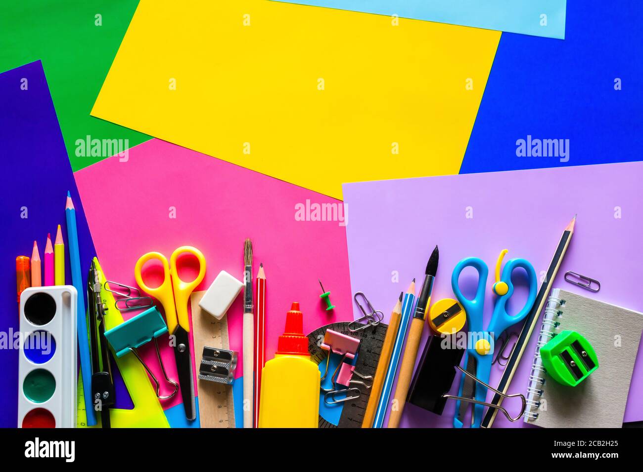 Schulbedarf für das Studium auf einem mehrfarbigen Hintergrund mit Platz Für Text Stockfoto