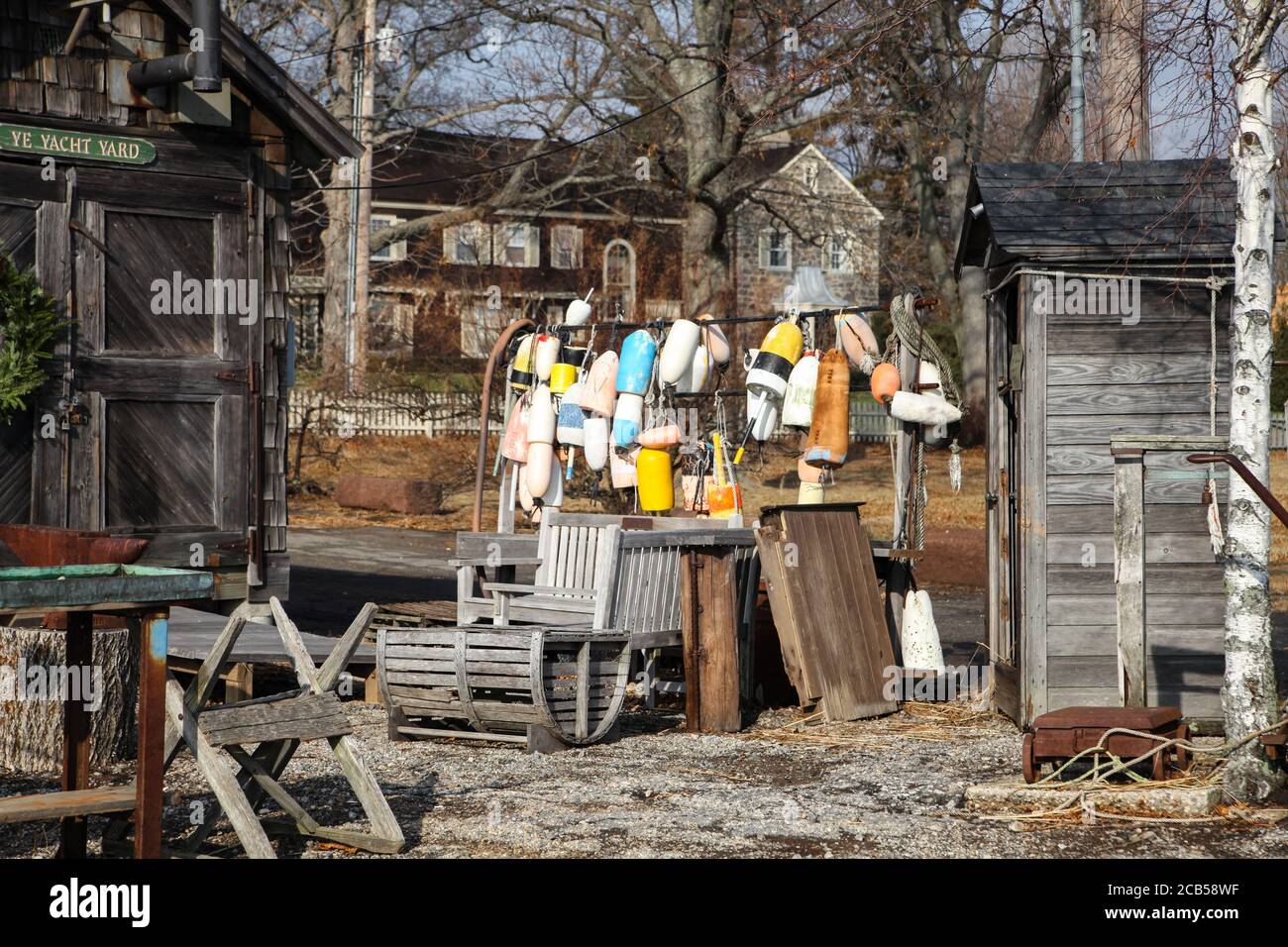 Der alte rustikale Schuppen auf der linken Seite und ein Haufen bunter Bootsfender in der Mitte in Southport, Fairfield, CT. Stockfoto