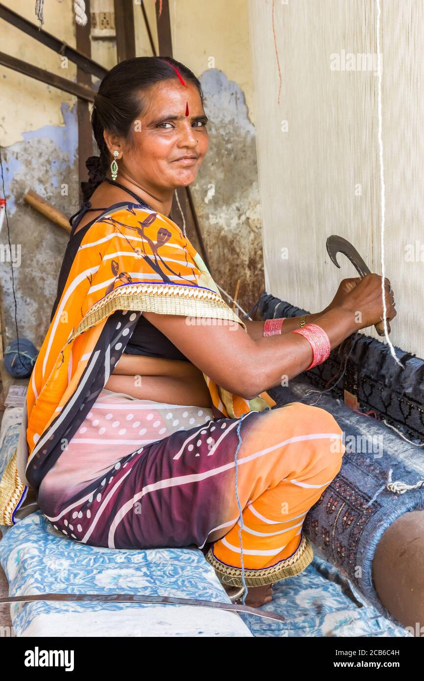 Indische Frau, die einen handgefertigten Teppich in Jaipur, Indien webt Stockfoto