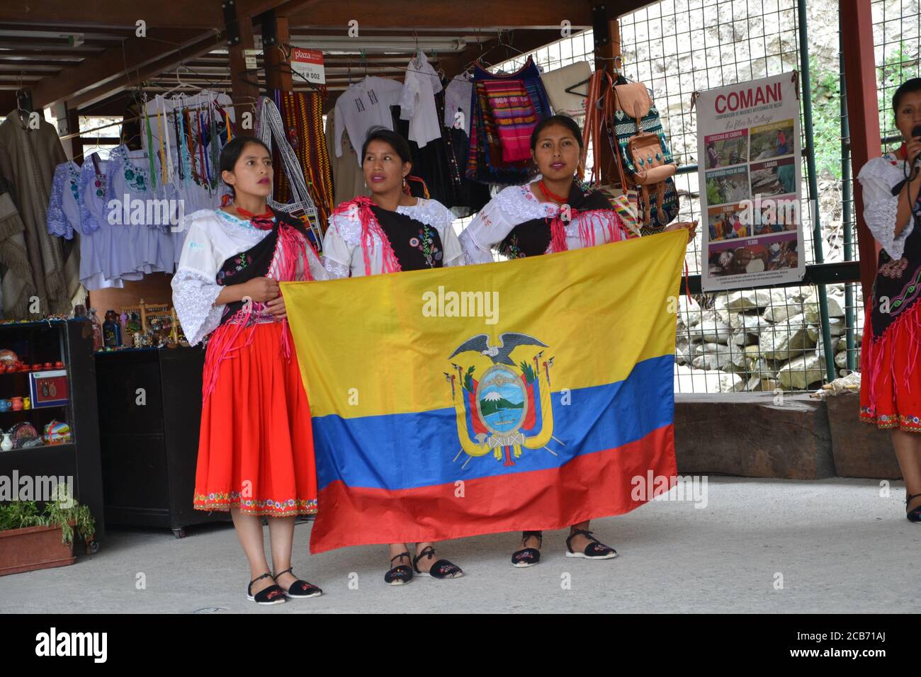 Ecuadorianische Ureinwohner in traditioneller Kleidung halten die Nationalflagge. Ecuador. Stockfoto