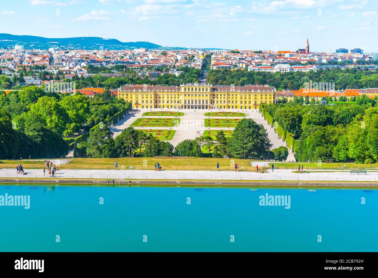 WIEN, ÖSTERREICH - 23. JULI 2019: Schloss Schönbrunn, Deutsch - Schloss Schönbrunn, und großer Parterre - Französischer Garten mit schönen Blumenbeeten. Blick von der Gloriette. Wien, Österreich. Stockfoto