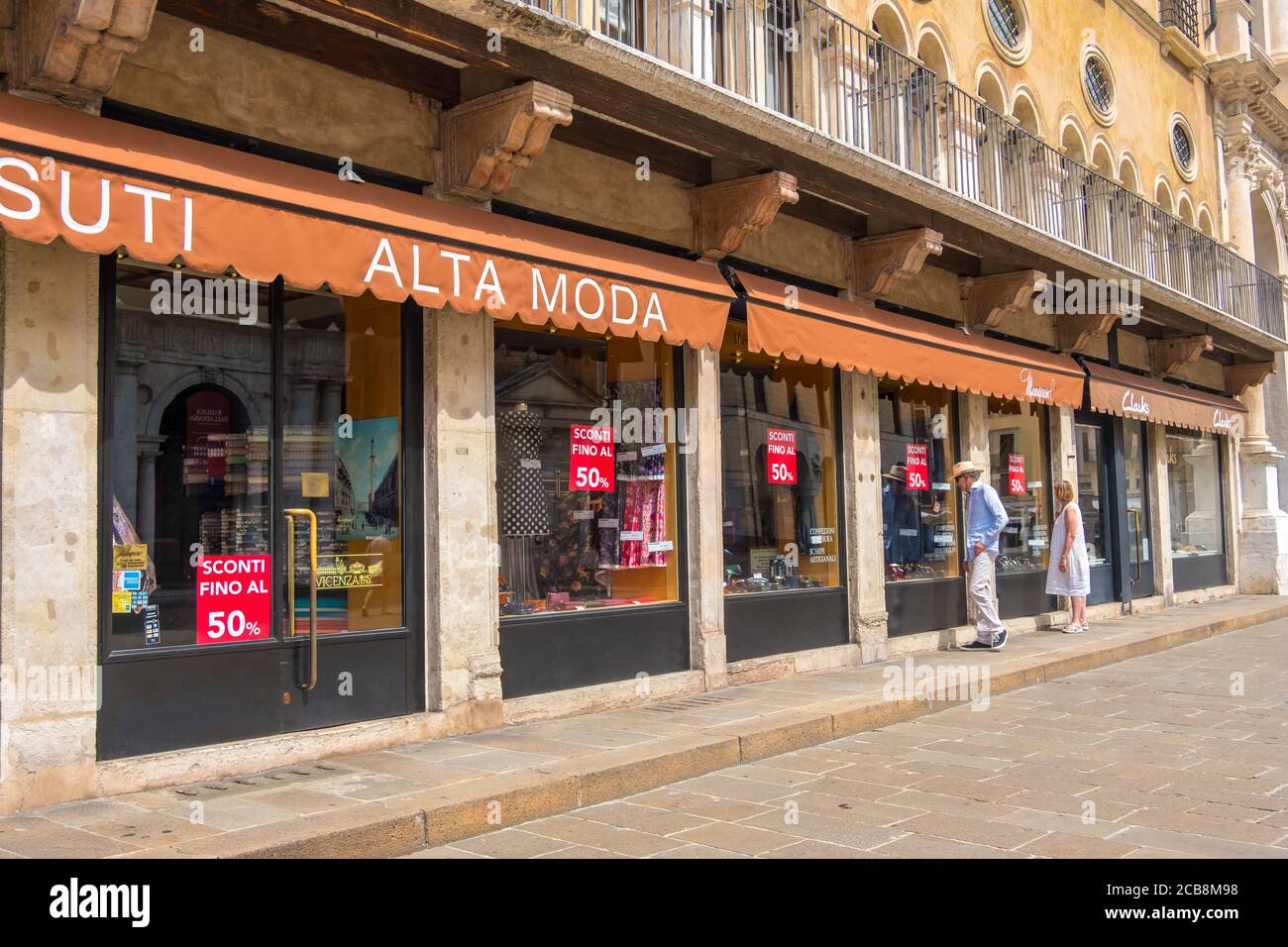 Vicenza, Italien - 12. August 2019: Ein Mann und eine Frau blicken auf ein Schaufenster auf der Piazza dei Signori in Vicenza, Region Venetien Stockfoto