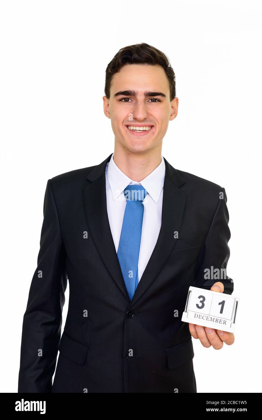 Studioaufnahme des jungen gut aussehenden kaukasischen Geschäftsmann Holding 31 Dezember Kalender vor weißem Hintergrund isoliert Stockfoto