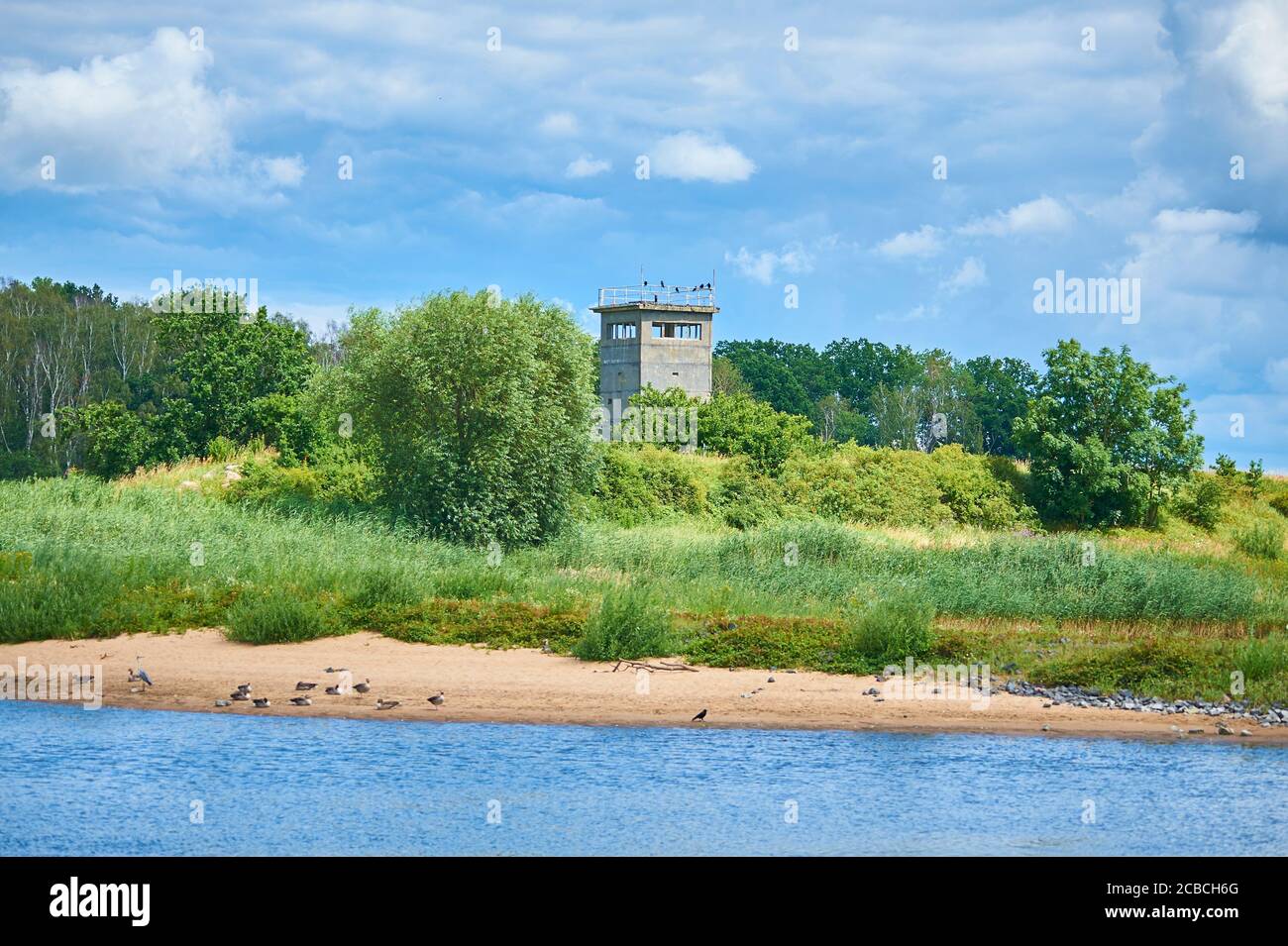 Ein alter Wachturm und ein Teil der Mauer der ehemaligen Grenze zwischen Ost- und Westdeutschland an der Elbe, heute ein Denkmal Stockfoto