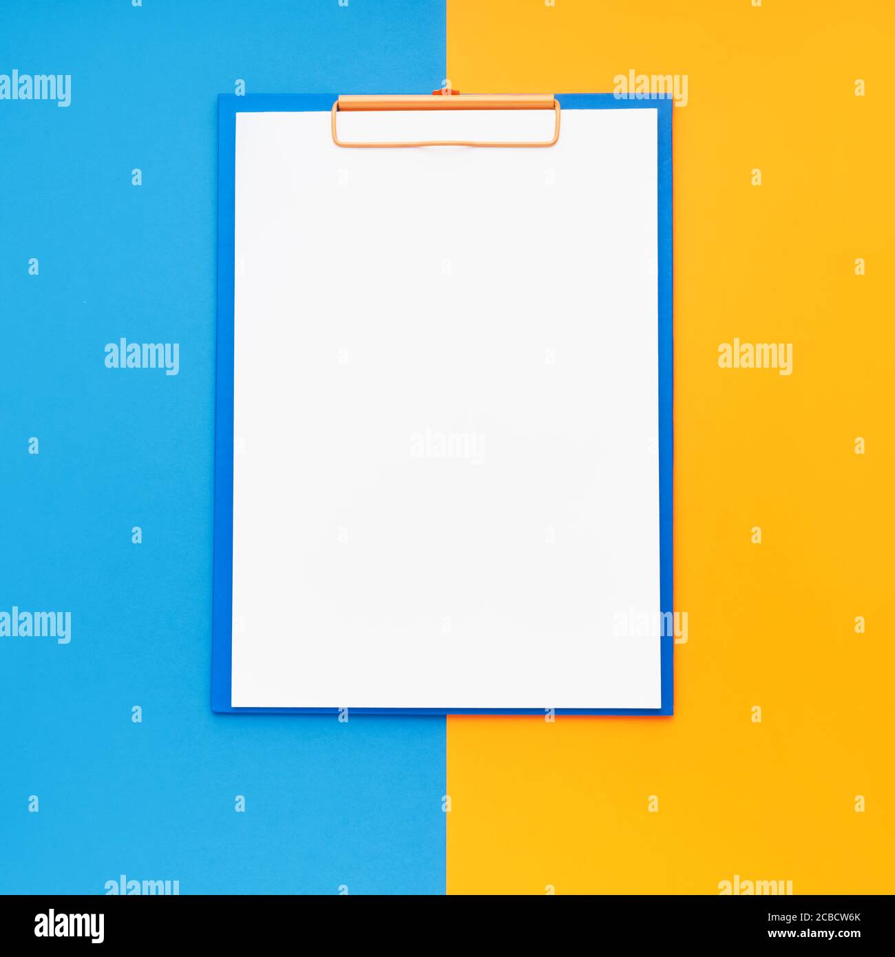Leeres Clipboard-Modell auf blau-orangefarbenem Hintergrund. Draufsicht, Kopierbereich. Zurück zur Schule, Deadline, Morgenkonzept. Stockfoto