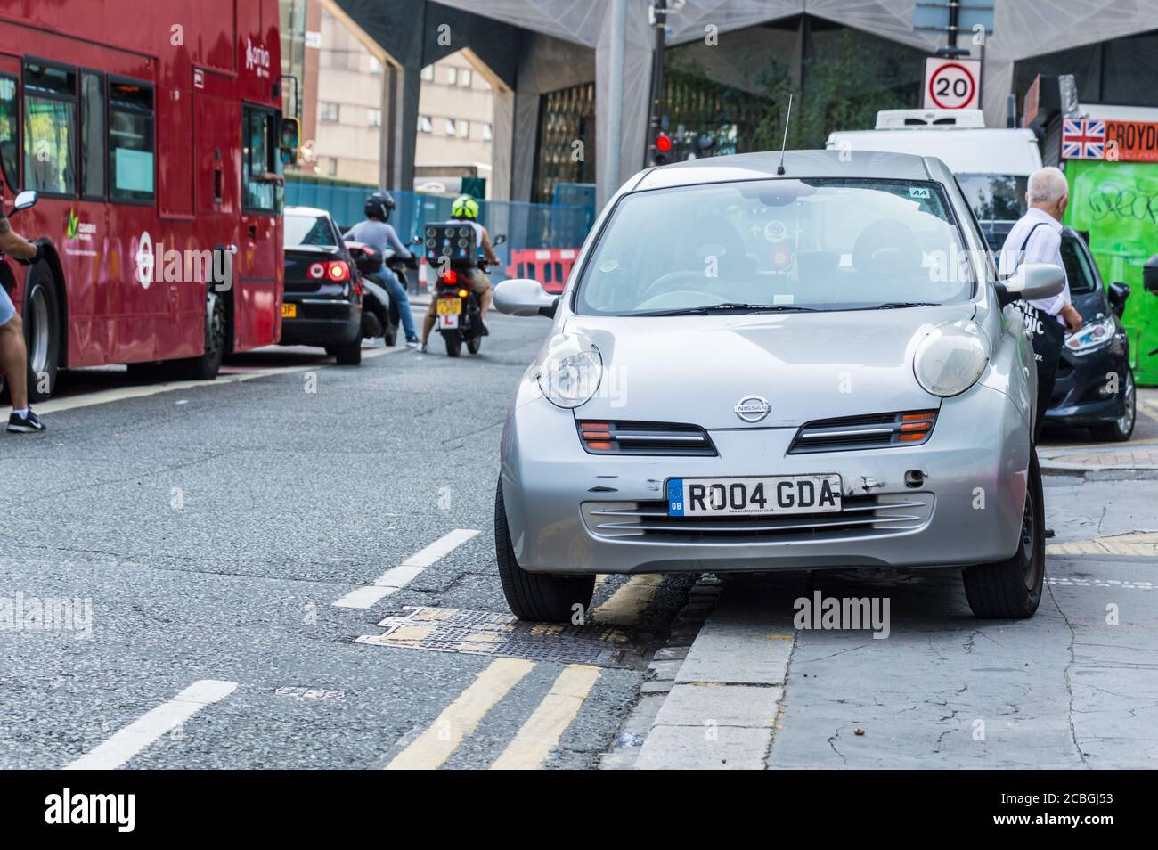 Parken auf dem Bürgersteig auf der geschäftigen Straße in London, während der Tag den Straßenbelag behindert Verkehr Stockfoto