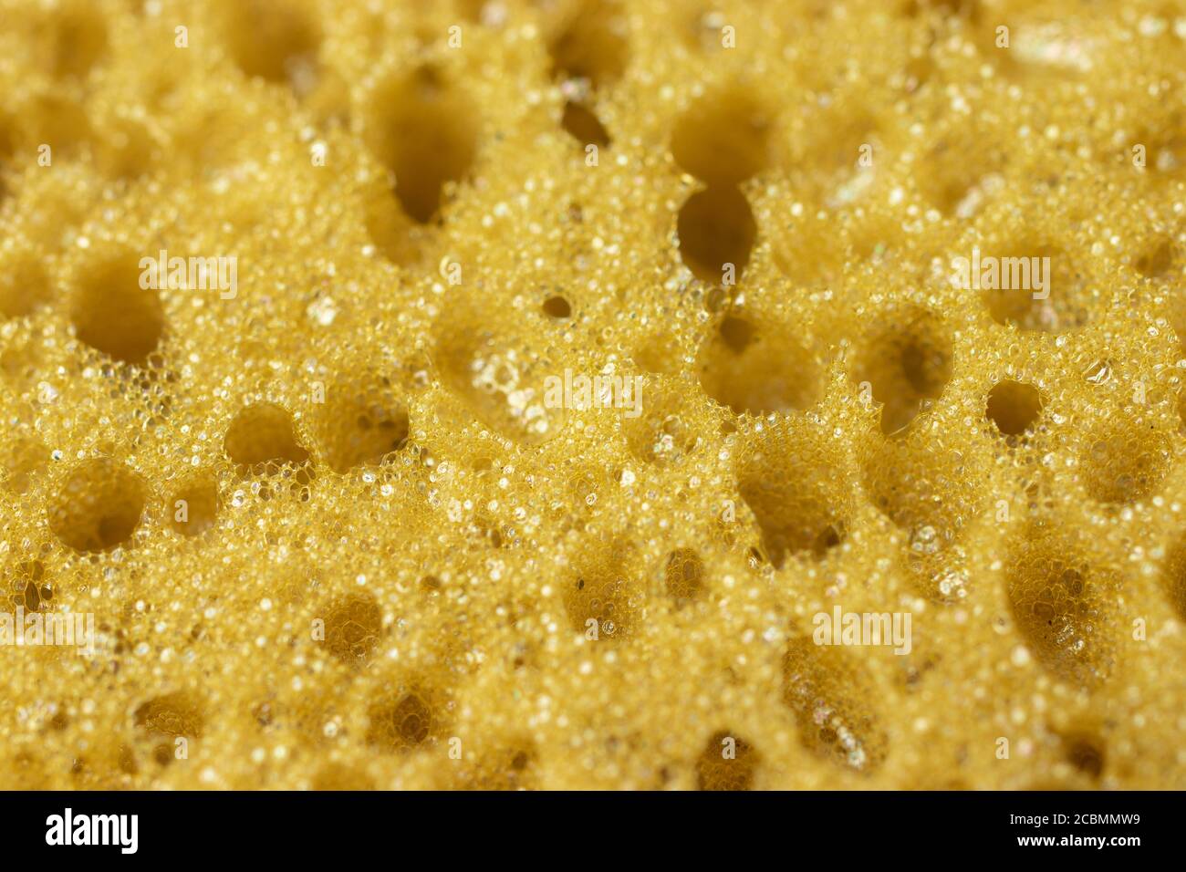 Gelber Schwamm perforierte Textur Hintergrund Stockfoto
