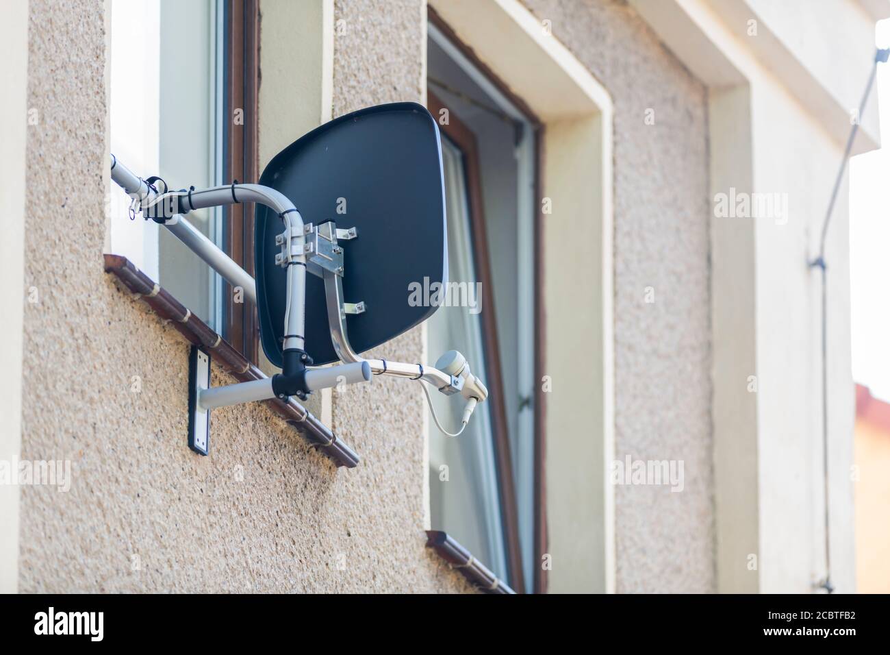 Satellitenschüssel im Fensterbereich eines Hauses installiert Stockfoto