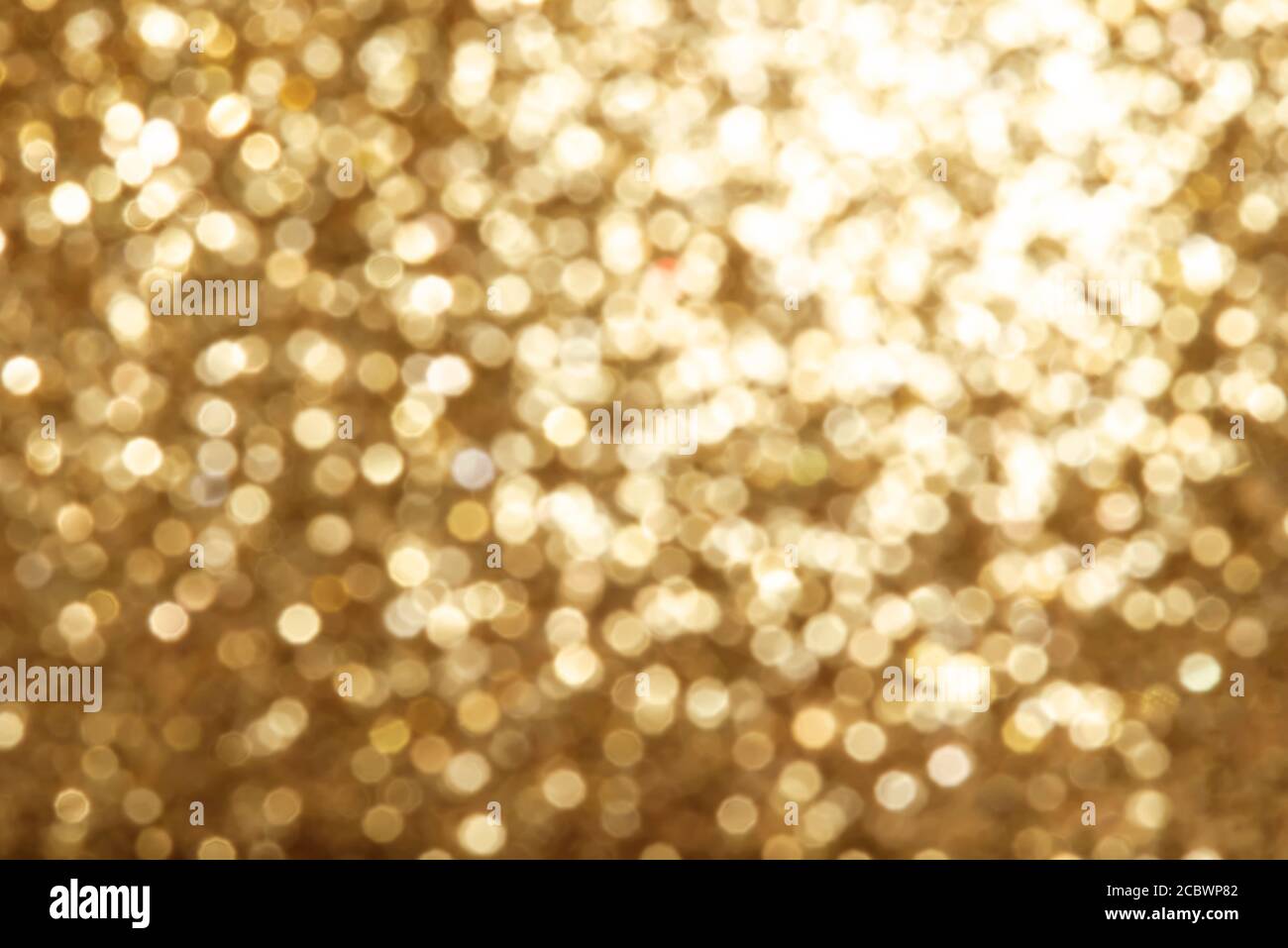 Helle runde goldene Farbe Licht Bokeh, lebendige Champagnerfarbe Hintergrund Stockfoto