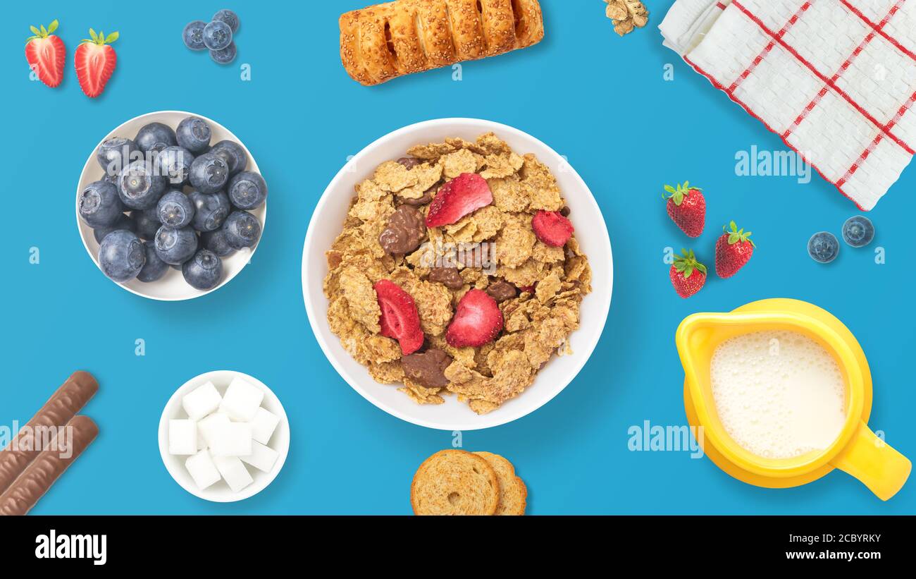 Tabelle Set von einem gesunden Frühstück. Blick von oben auf ein Frühstück mit Obst, Müsli, Gebäck, Schokolade und Milch. Bunte und gesunde Mahlzeit. Bezogen auf energ Stockfoto