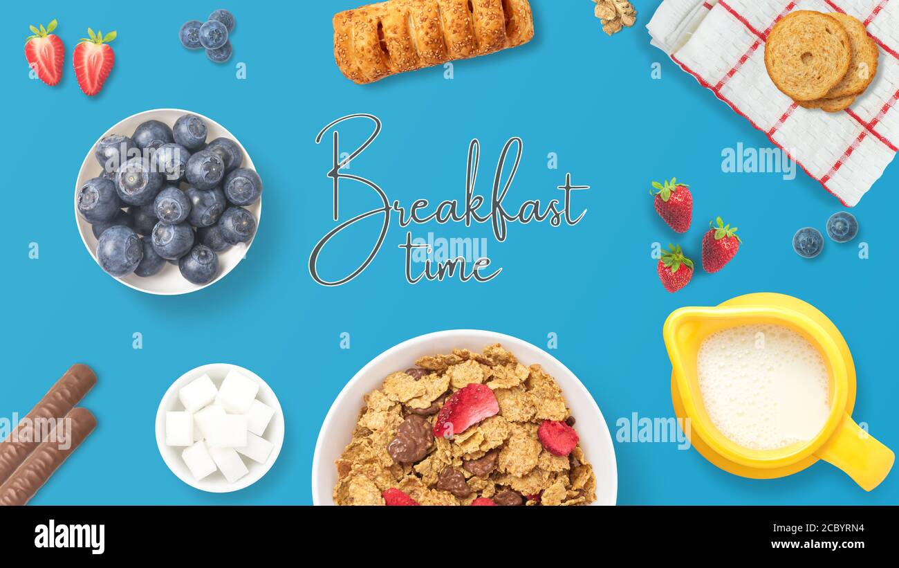 Tabelle mit dem Text Frühstückszeit. Blick von oben auf ein Frühstück mit Obst, Müsli, Gebäck, Schokolade und Milch. Bunte und gesunde Mahlzeit. Verbunden Stockfoto
