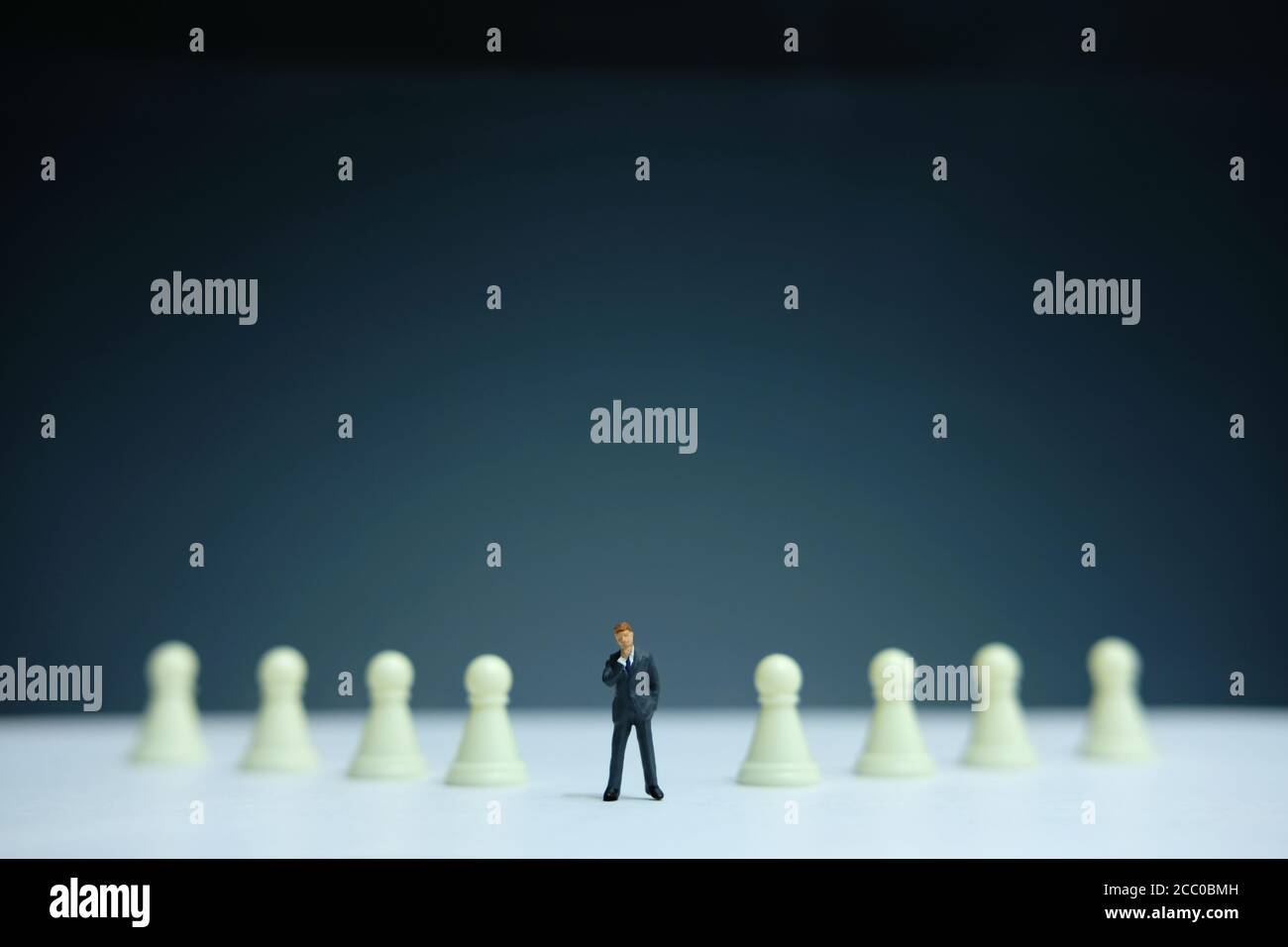 Miniatur-Geschäftskonzept - Geschäftsmann steht in Schach Pfandlinie Stockfoto