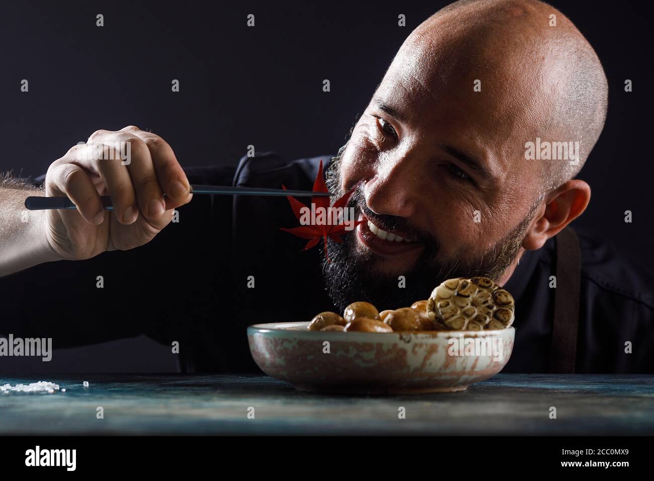 Gekochte junge Kartoffeln mit Öl und gerösteten Knoblauch, in einer Holzschale. Stockfoto