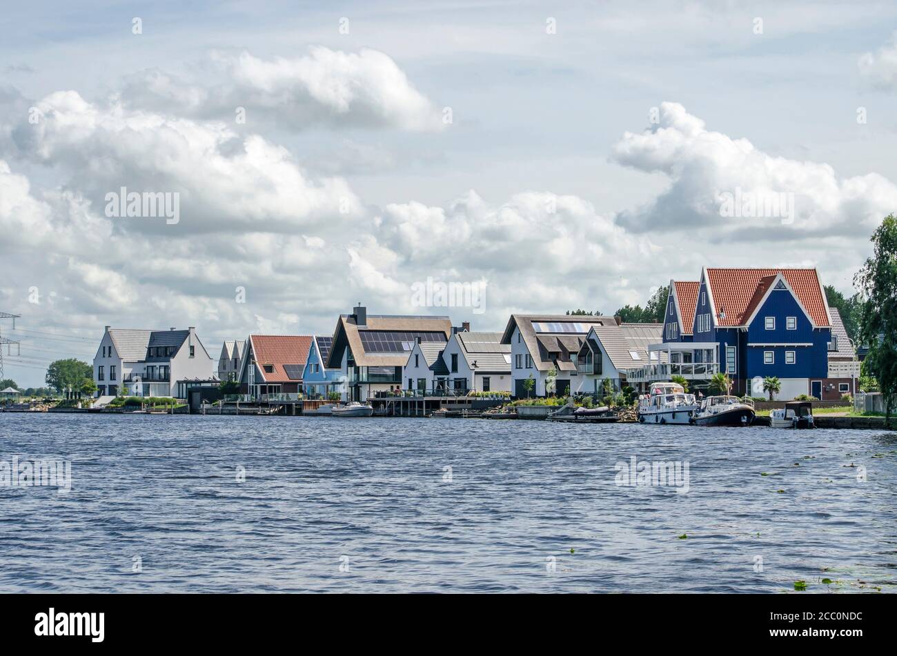 Graffhorst, Niederlande, 2. August 2020: Reihe von kürzlich errichteten Luxushäusern mit traditionellen Elementen aus verschiedenen Materialien, darunter Holz, pl Stockfoto