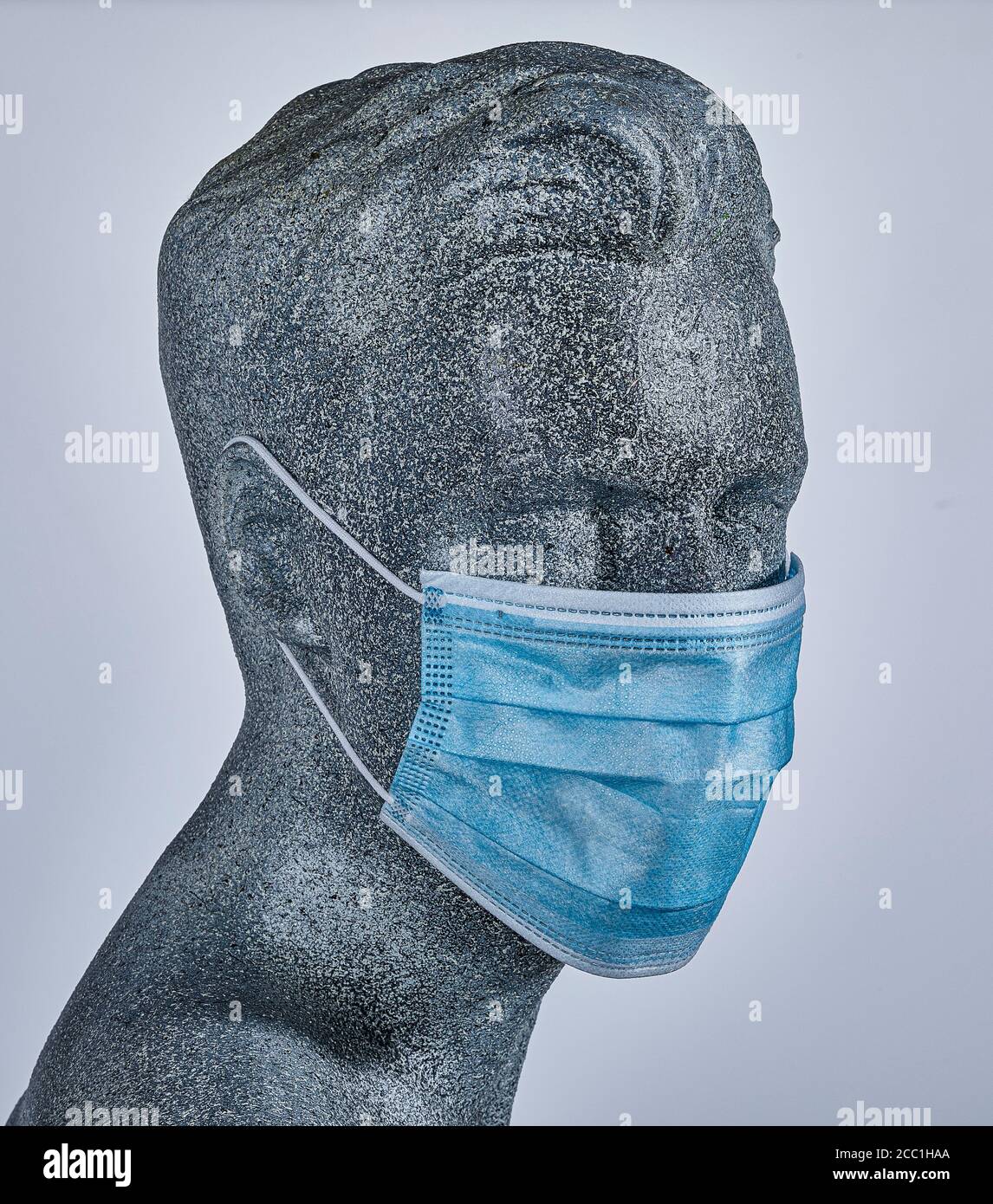 Männliche Display-Dummy, trägt eine schützende medizinische Gesichtsmaske, auf grauem Hintergrund Stockfoto