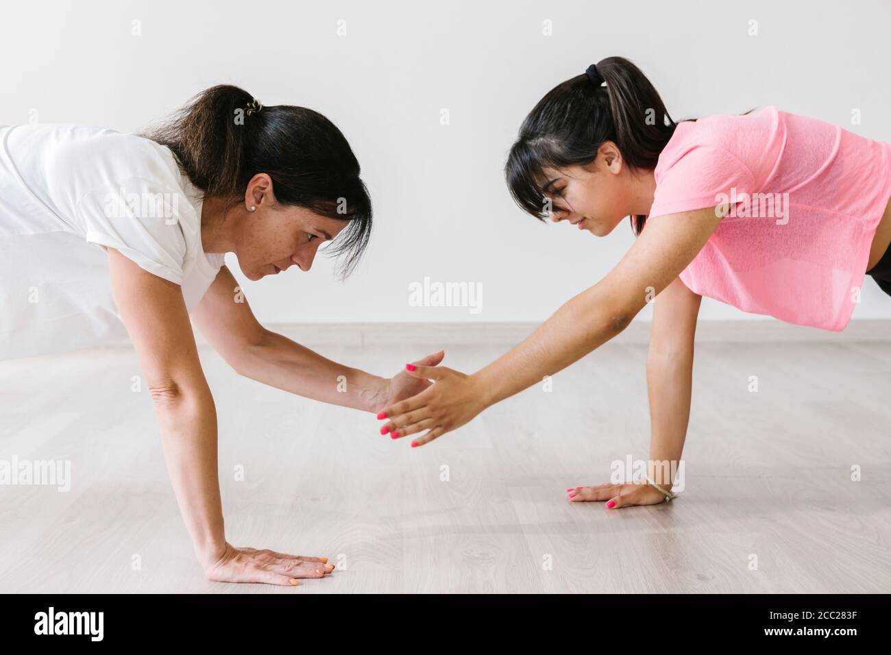Frau und Mädchen trainieren gemeinsam im Fitnessstudio Stockfoto