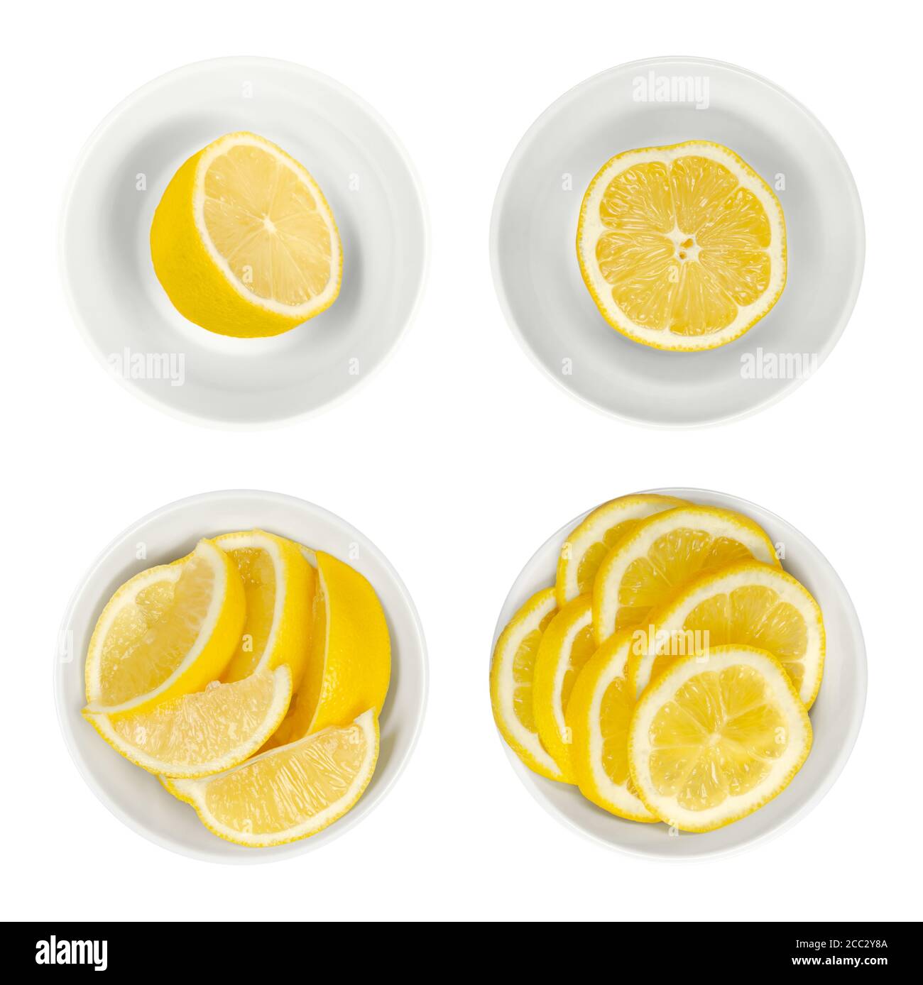Zitronen in weißen Glasschalen. Frisch geschnittene Zitronenhälften, Keile und Scheiben. Reife und gelbe Zitrusfrüchte, für kulinarische Zwecke verwendet. Citrus limon. Stockfoto
