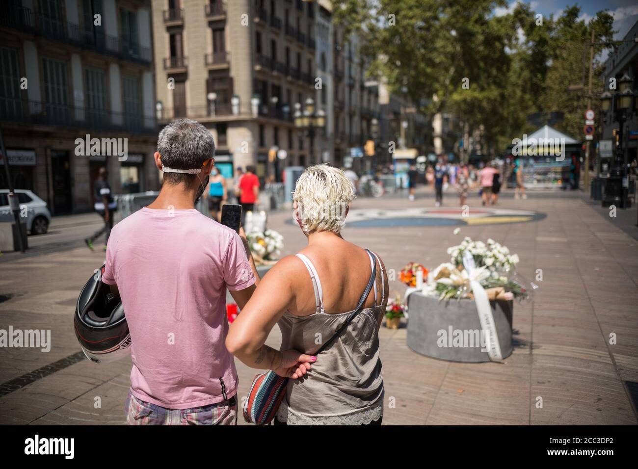 Ein Paar fotografiert die Tribute an die Opfer des Barcelona-Attentats.drei Jahre nach dem Anschlag auf Barcelona wird in Las Ramblas eine Hommage an die Opfer gemacht. Stockfoto