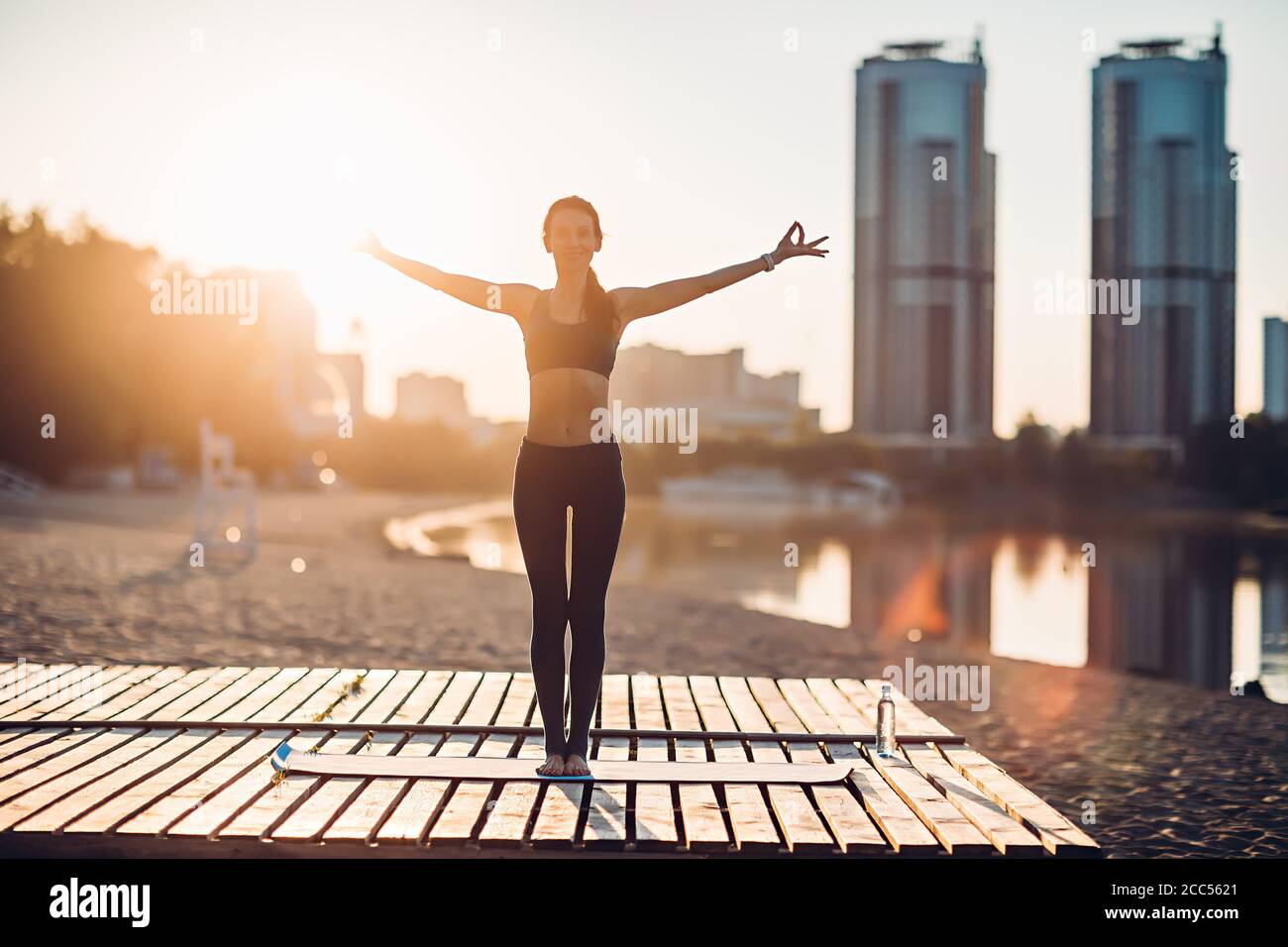 Sportlerin macht Yoga bei Sonnenaufgang Stockfoto