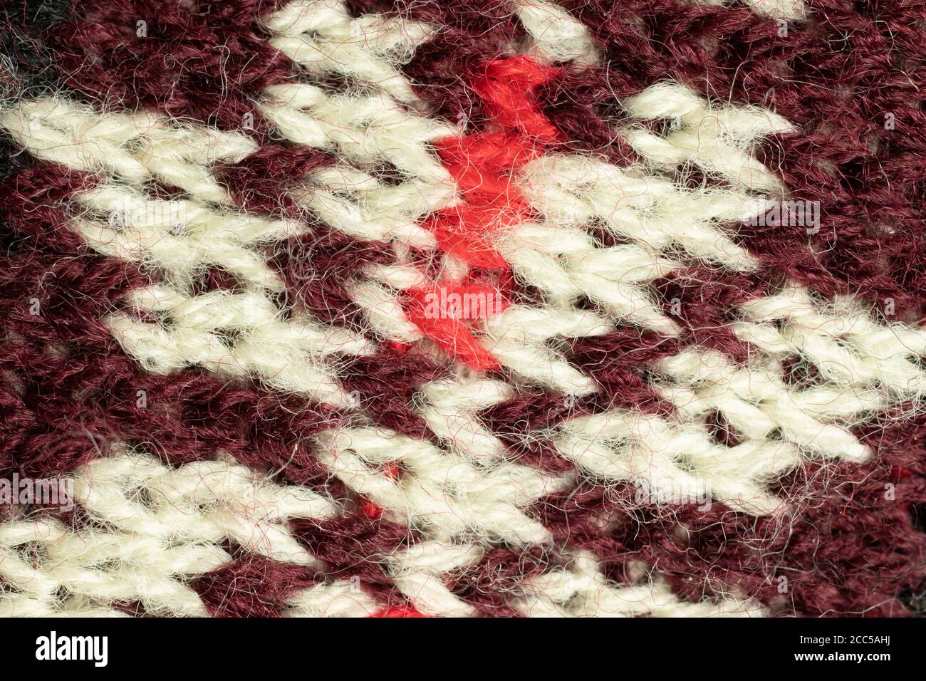 Weiße und rote Wolle Textur Hintergrund. Mustertextilien Stockfoto