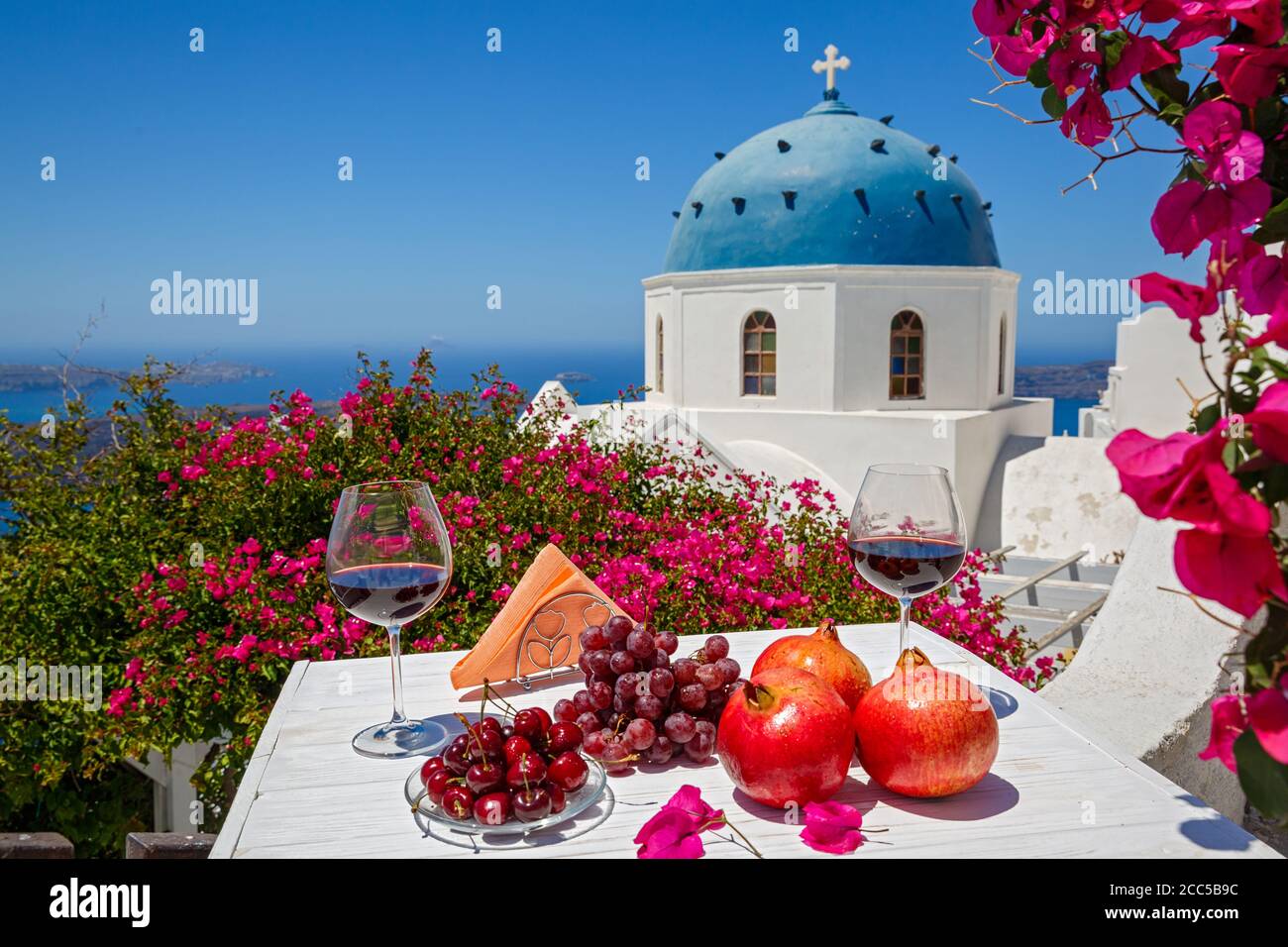 Zwei Gläser Rotwein und Obst auf dem Hintergrund Des Meeres in Griechenland Stockfoto