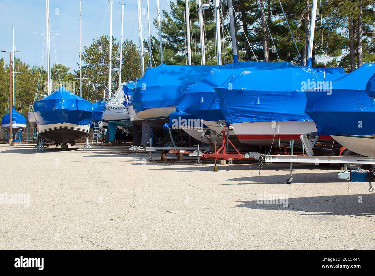 Schützende blaue Plane auf Booten in Michigan Outdoor-Lagerplatz Stockfoto