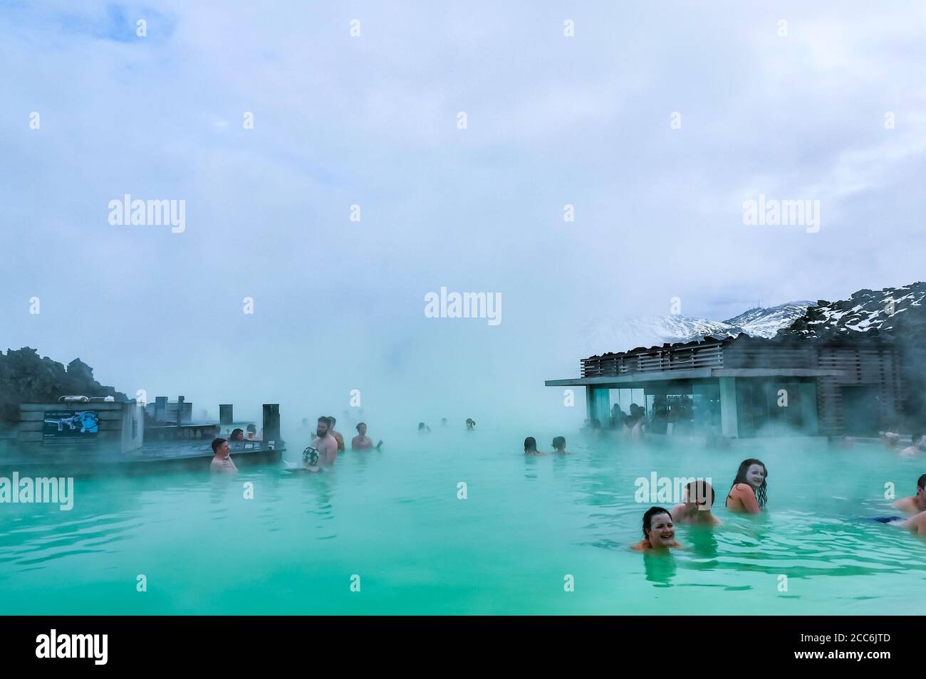 Menschen, die im Winter in heissem geothermalem Thermalwasser im Blue Lagoon Resort baden, Island Stockfoto