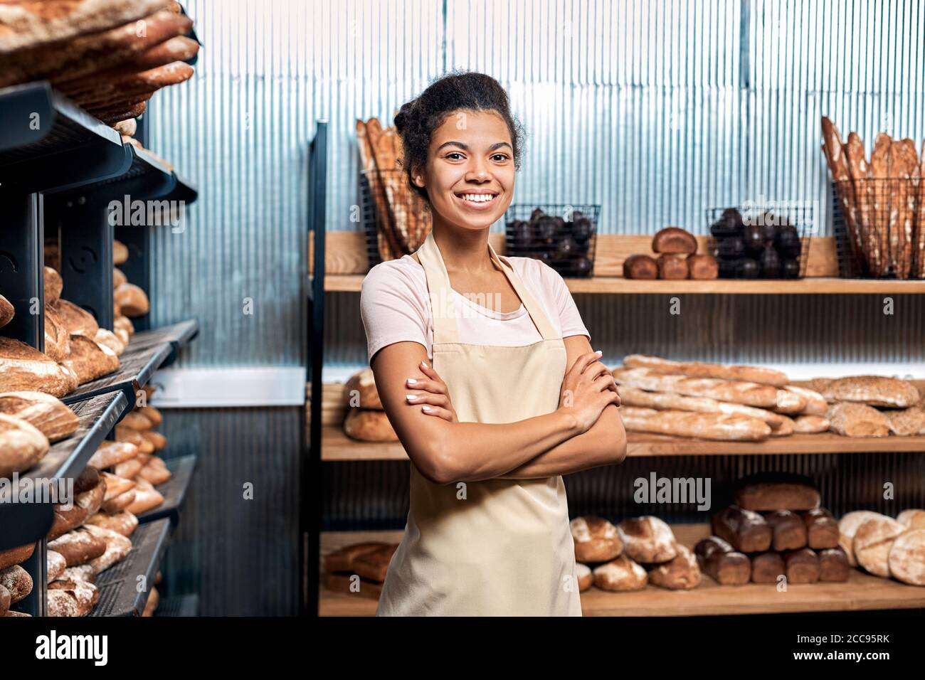 Junge Erwachsene Frau, die in der Bäckerei der Familie steht Stockfoto