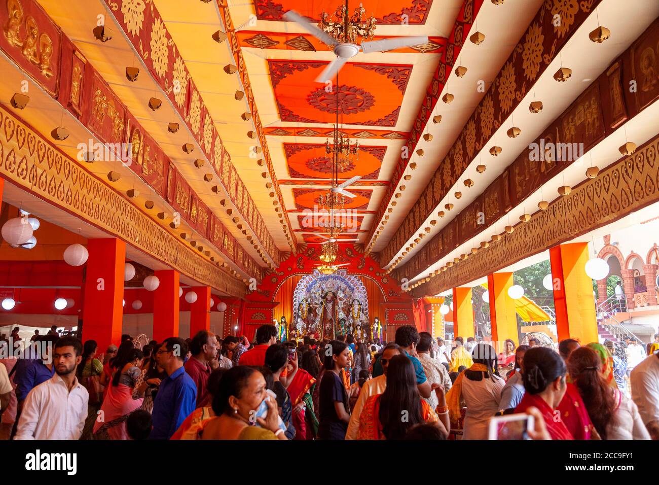 Ansicht einer Statue der Göttin Durga, während eifrige Anhänger sich versammeln Ihre Gebete darbringen Stockfoto