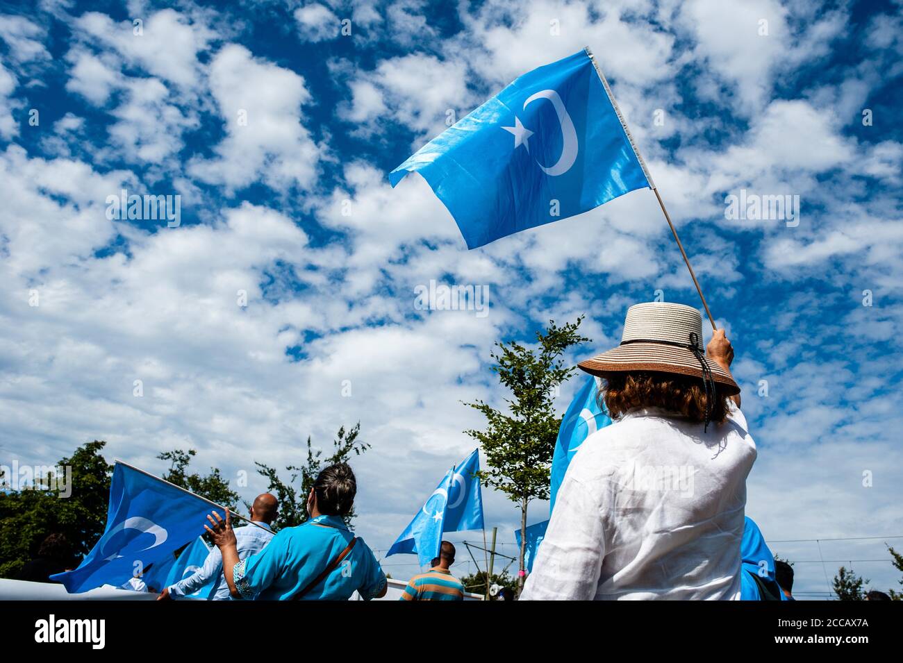 Während der Demonstration winken Demonstranten Uiguren-Fahnen.Extinction Rebellion Fashion Action NL (XRFA) hat sich mit der Ostturkestan Organization Alliance zusammengetan, um die öffentliche Aufmerksamkeit auf die Diskriminierung der Uiguren in China zu lenken. Demonstranten begannen am Koekamp, zur chinesischen Botschaft zu gehen, um eine offizielle Erklärung abzugeben, und Druck auf die niederländische Regierung und die chinesische Botschaft auszuüben, jetzt zu handeln und diese ethnische Säuberung zu stoppen. Stockfoto