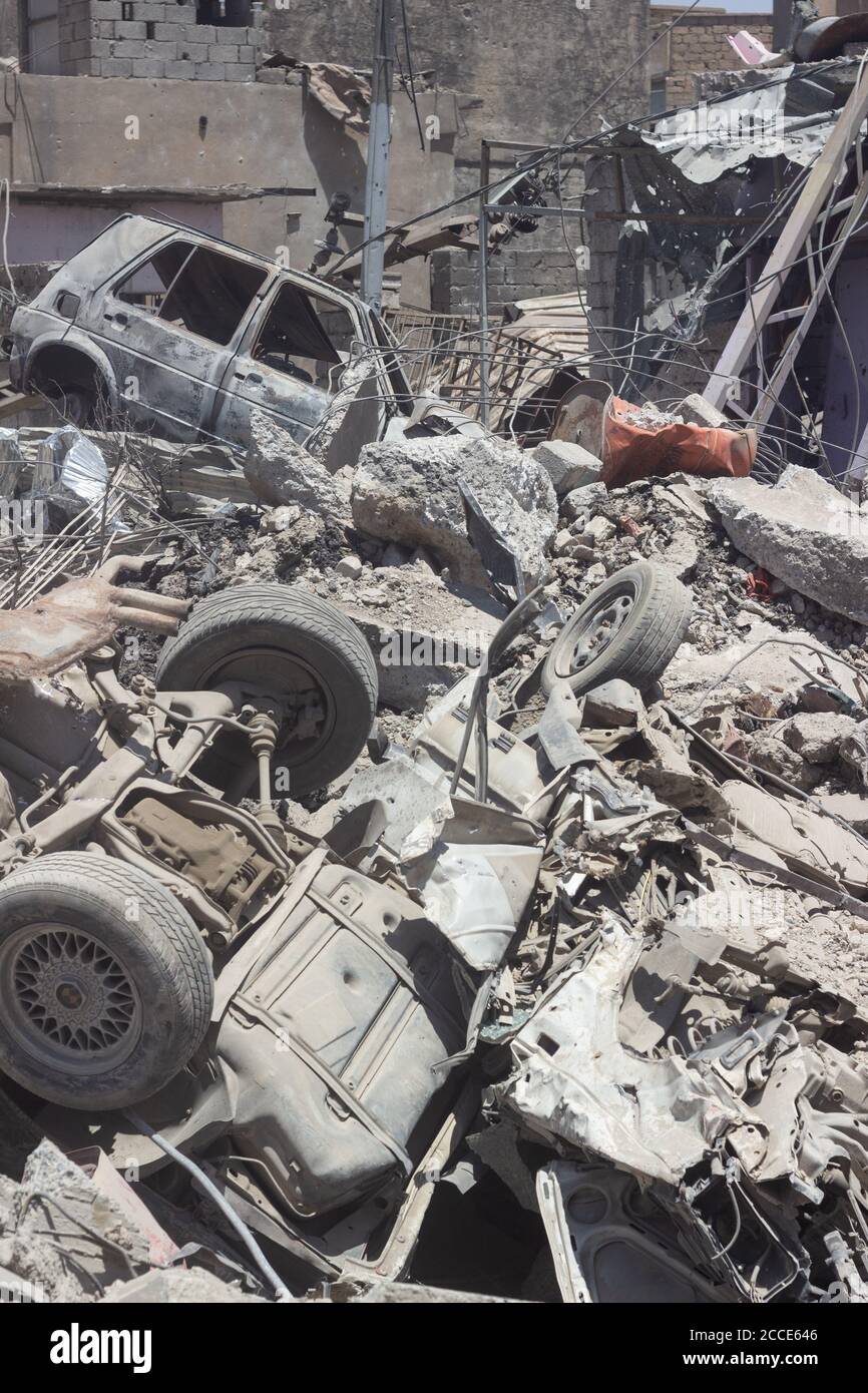 Zerstörte Autos und Trümmer von Gebäuden verwüsten die Nachbarschaft von Zanjili. Aufgenommen während der Schlacht um Mossul im Jahr 2017. Stockfoto