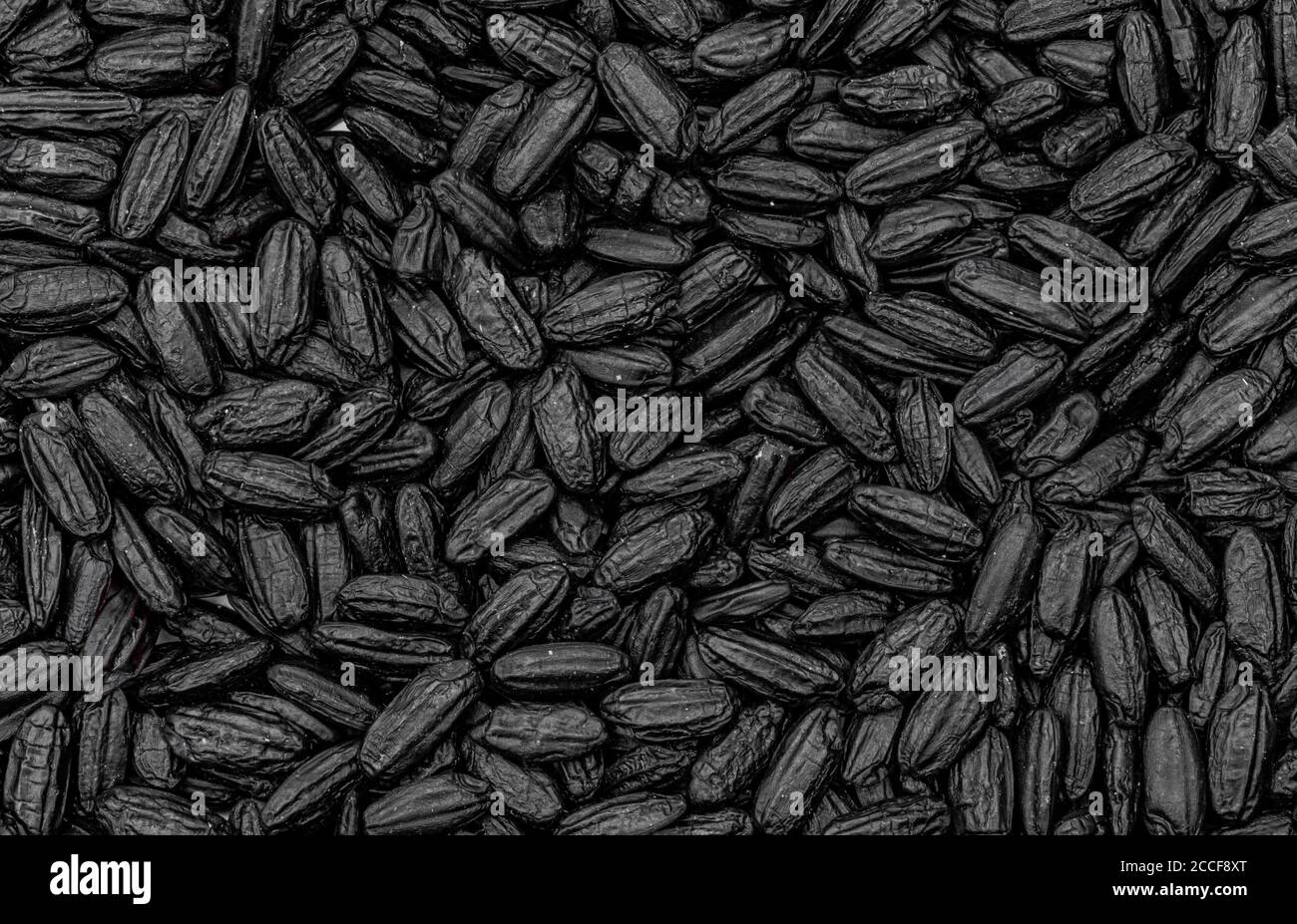 Schwarze Reiskörner als Hintergrundbild Stockfoto