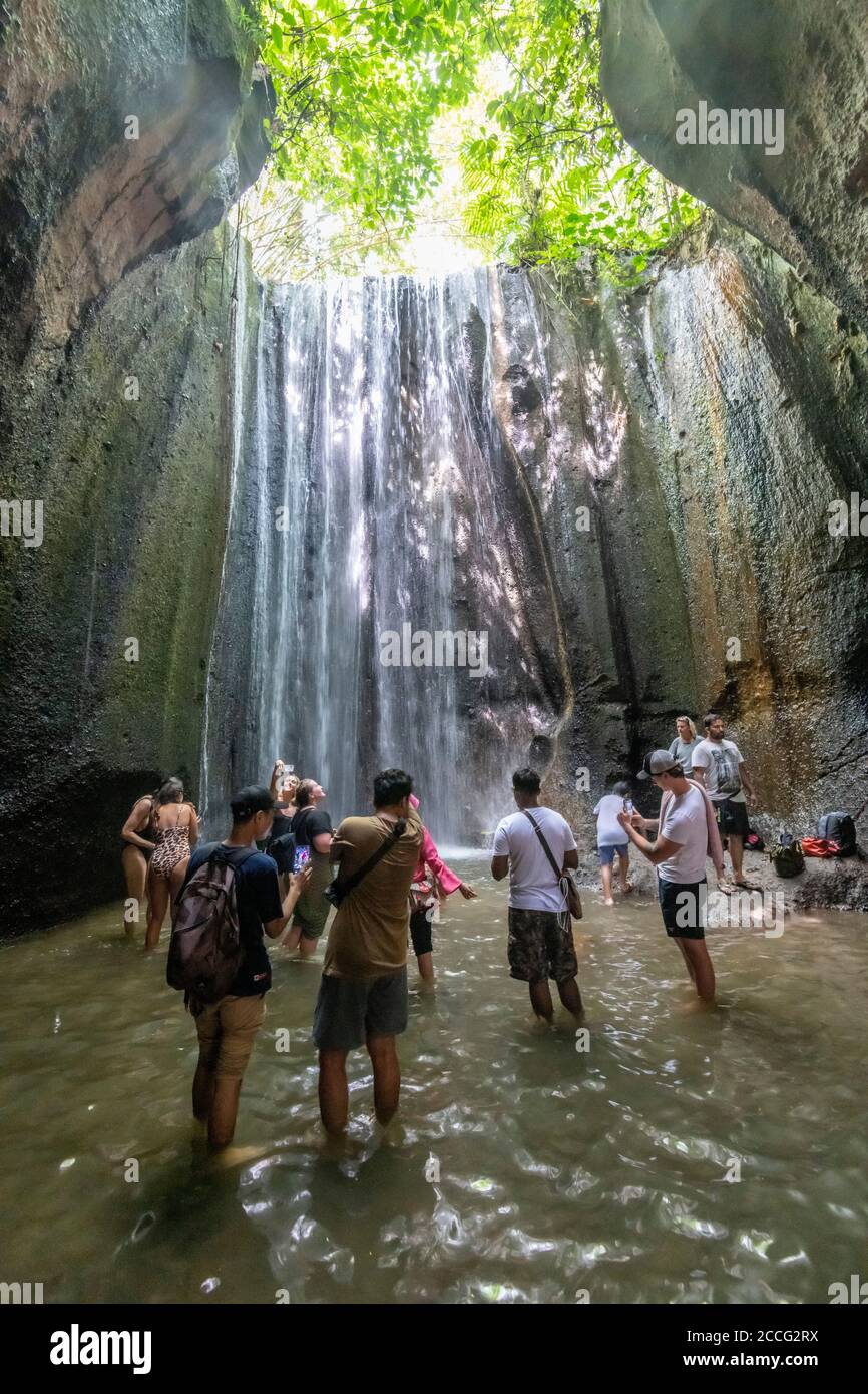 Tukad Cepung Wasserfall ist ein herrlicher Wasserfall innerhalb eines kleinen Höhlensystems und ist eine beliebte Touristenattraktion in Bali. Die Lichtschächte und Wasser s Stockfoto