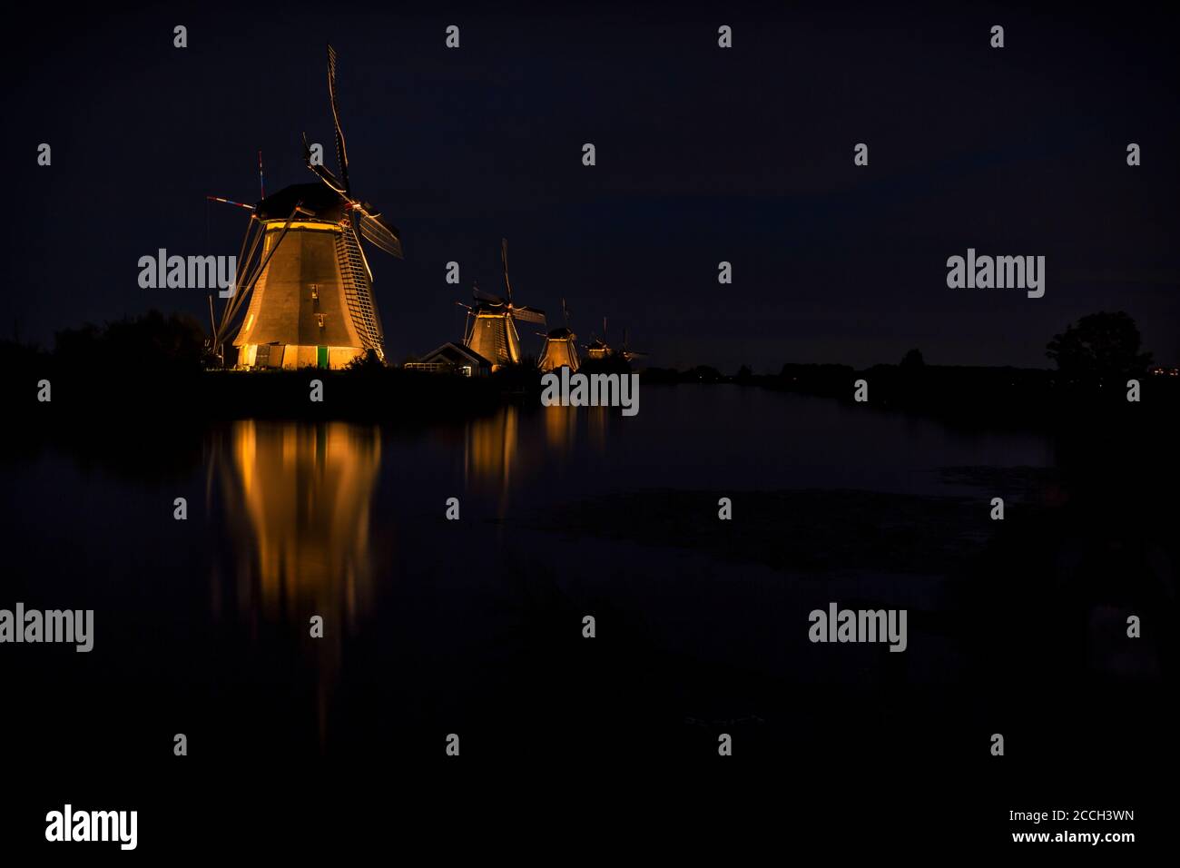 Mühlen bei Kinderdijk (Niederlande) am Abend beleuchtet Stockfoto