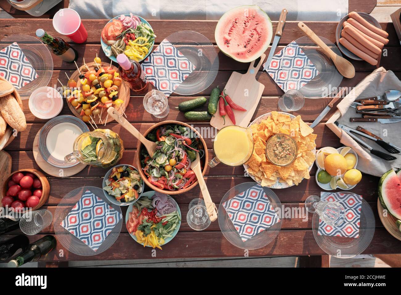 Hochwinkelansicht des Feiertagtisches mit Gemüsesalatobst Und verschiedene Snacks im Freien Stockfoto