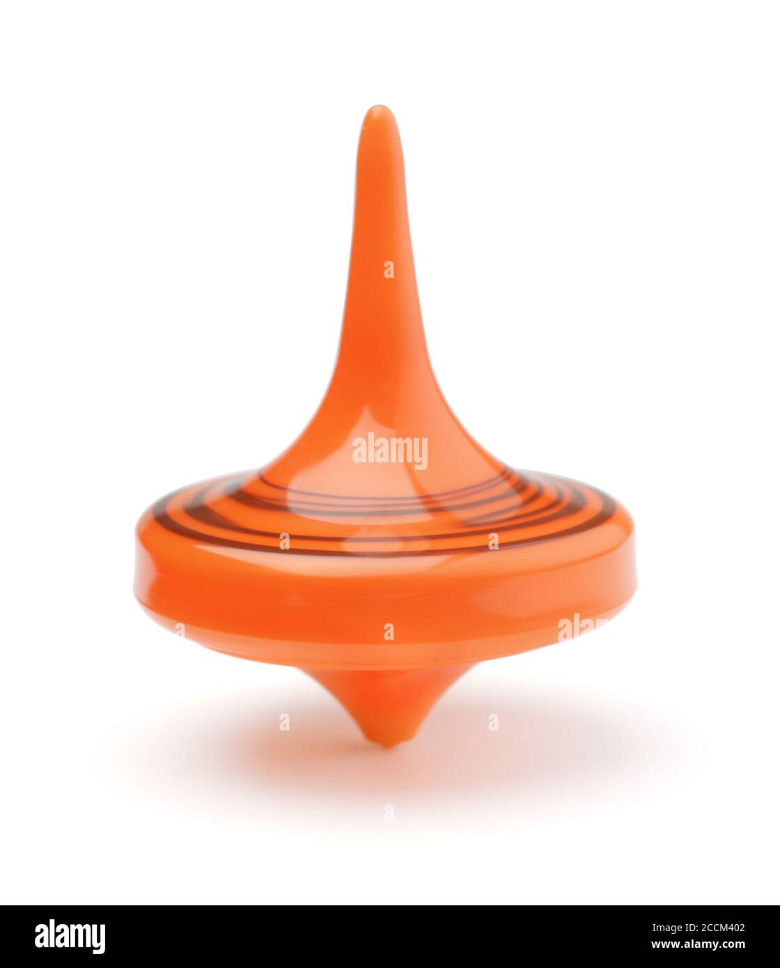 Rotierende orange Spielzeug Spinning top isoliert auf weiß. Stockfoto