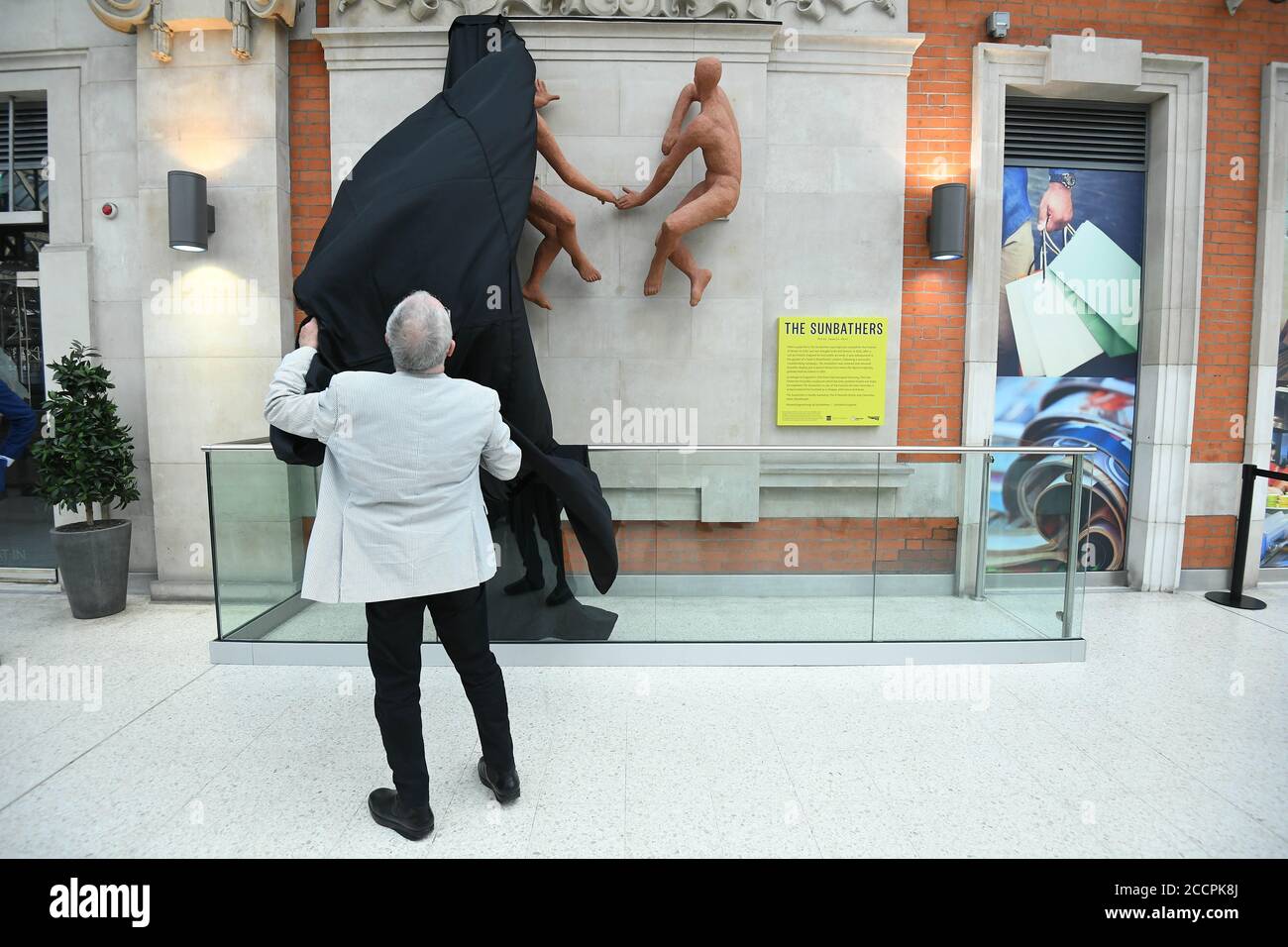 Sir Peter Hendy, Vorsitzender von Network Rail, enthüllt die Sonnenanbeter, eine Skulptur des ungarischen Künstlers Peter Laszlo Peri kehrt nach fast 70 Jahren Abwesenheit nach London Waterloo zurück. Die Skulptur, die ursprünglich am Eingang der U-Bahnstation ausgestellt wurde, um Besucher des Festival of Britain im Jahr 1951 willkommen zu heißen, galt als verloren, wurde aber auf dem Gelände eines südöstlichen Londoner Hotels wiederentdeckt, das gebrochen und in blassrosa gestrichen war. Eine Crowdfunding-Kampagne hat Geld gesammelt, um die Farbschichten abzutragen und sie wieder in die ursprüngliche, sonnenverwöhnte Terrakotta-Farbe zu bringen. Stockfoto