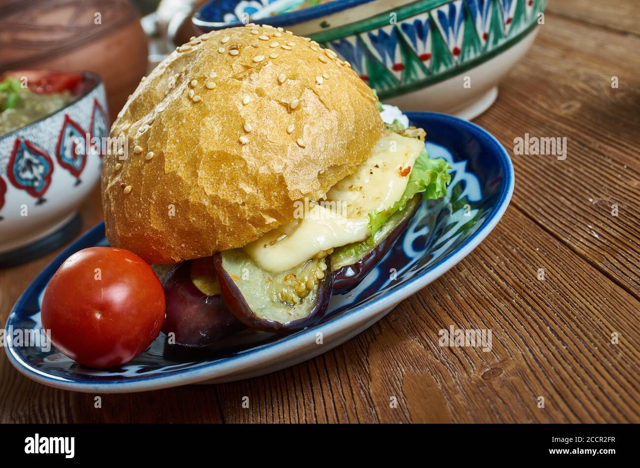 Halloumi Aubergine Burger, von Auberginen durch Frittieren in Semmelbröseln bis knusprig und golden, bevor sie in einem Burger-Brötchen mit gegrilltem Halloumi Füllung Stockfoto
