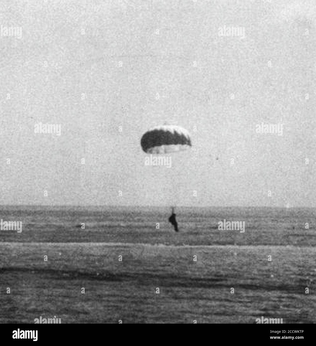 Japanischer Pilot mit Fallschirm steigt in Richtung Wasser ab, 17. April 1945. Stockfoto