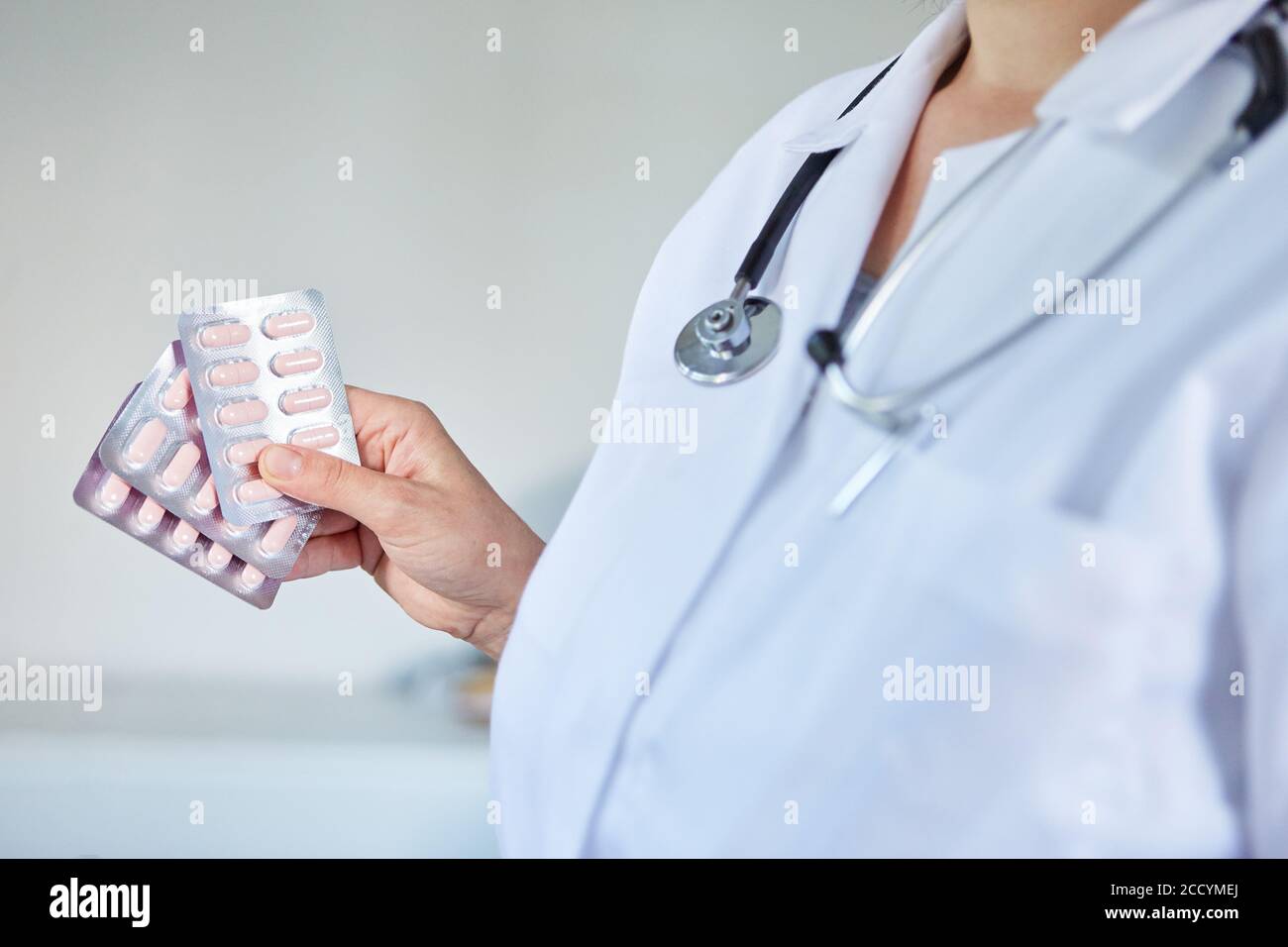 Ärztin in der Klinik zeigt Tabletten in Blisterpackung in Ihre Hand Stockfoto