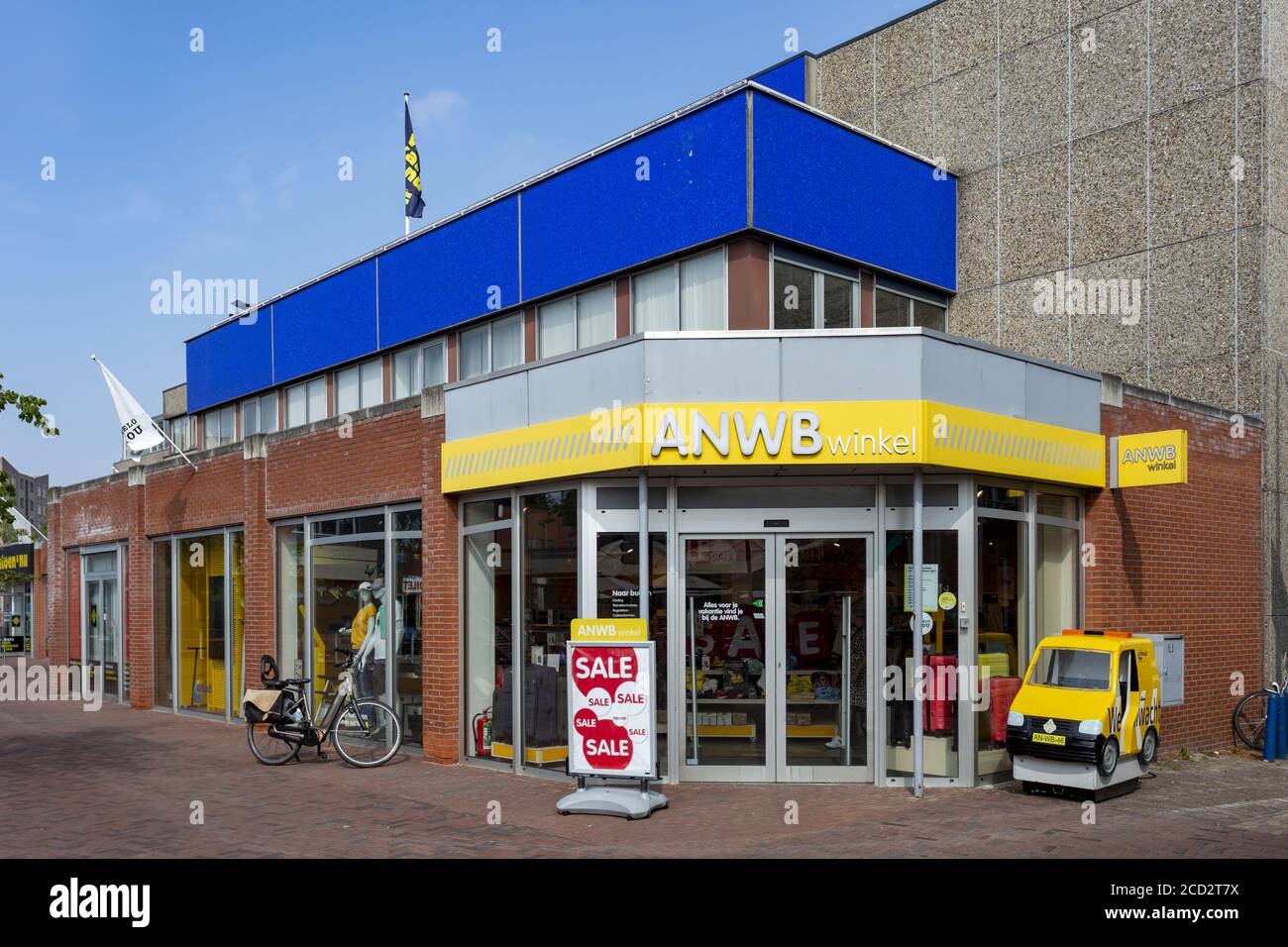 ALMELO, NIEDERLANDE - 14. Aug 2020: Ladenfront des niederländischen Fahrzeugverbandes ANWB mit farbenfroher Außenfassade und kleinem Spielzeugauto neben dem Eingang Stockfoto