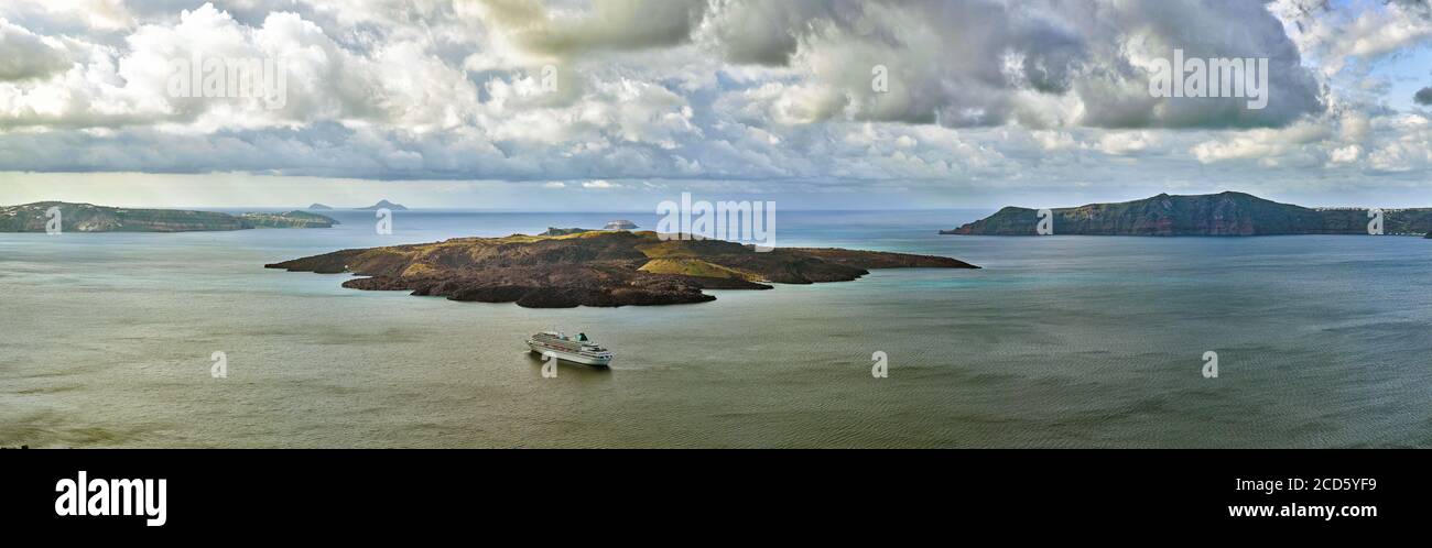 Panoramablick auf die Kameni Inseln und Kreuzfahrtschiff, Santorini, Griechenland Stockfoto