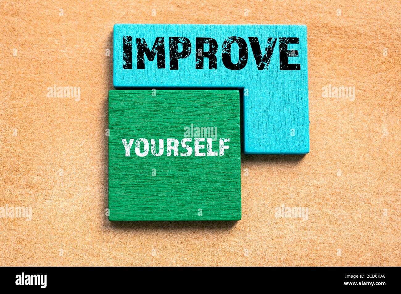 VERBESSERN SIE SICH. Farbige Holzblöcke, Puzzle und Geist Spiel. Orangefarbener Hintergrund Stockfoto