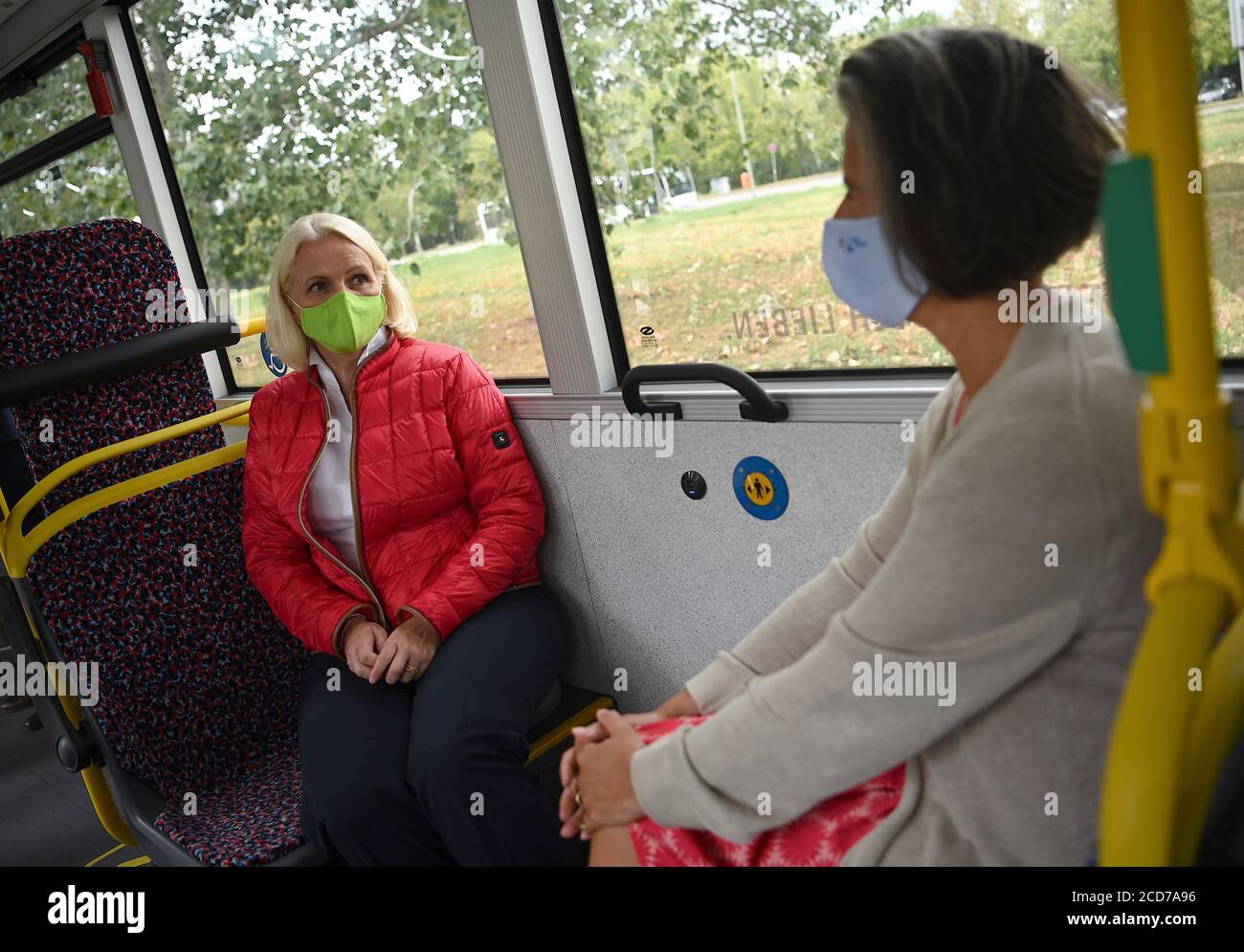 27. August 2020, Berlin: Regine Günther (Bündnis 90/die Grünen, l), Berliner Senatorin für Umwelt und Verkehr, sitzt gegenüber Tamara Zieschang (CDU), Staatssekretärin im Bundesministerium für Verkehr, Bau und Stadtentwicklung, mit einer Gesichtsmaske auf der Jungfernfahrt des neuen Gelenktriebbusses Solaris Urbino 18 der BVG. Foto: Britta Pedersen/dpa-Zentralbild/dpa Stockfoto