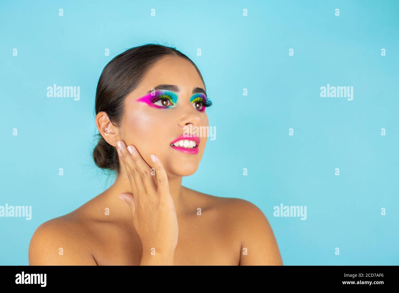 Schönheit Porträt von weiblichen Modell lächelnd mit lebendigen Make-up auf blauem Hintergrund. Stockfoto