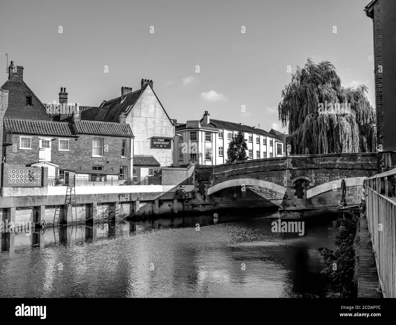 Ein Schwarz-Weiß-Foto von einem Blick auf die historische Fye Bridge und den traditionellen Mischief Pub in der Stadt Norwich, Norfolk. Aufgenommen an einem hellen und sonnigen Tag. Stockfoto
