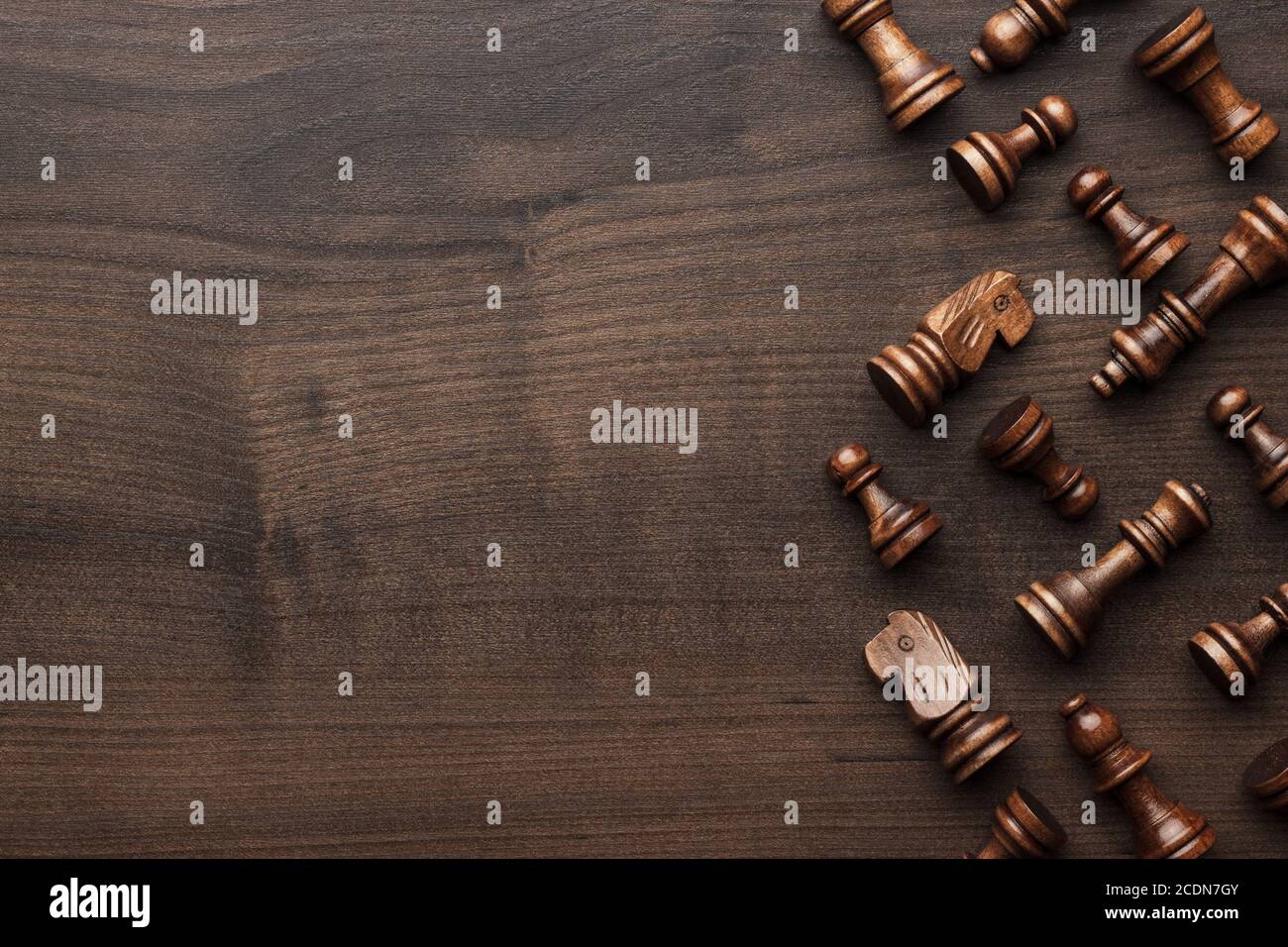 Schachfiguren auf braunem Holztisch Hintergrund Stockfoto