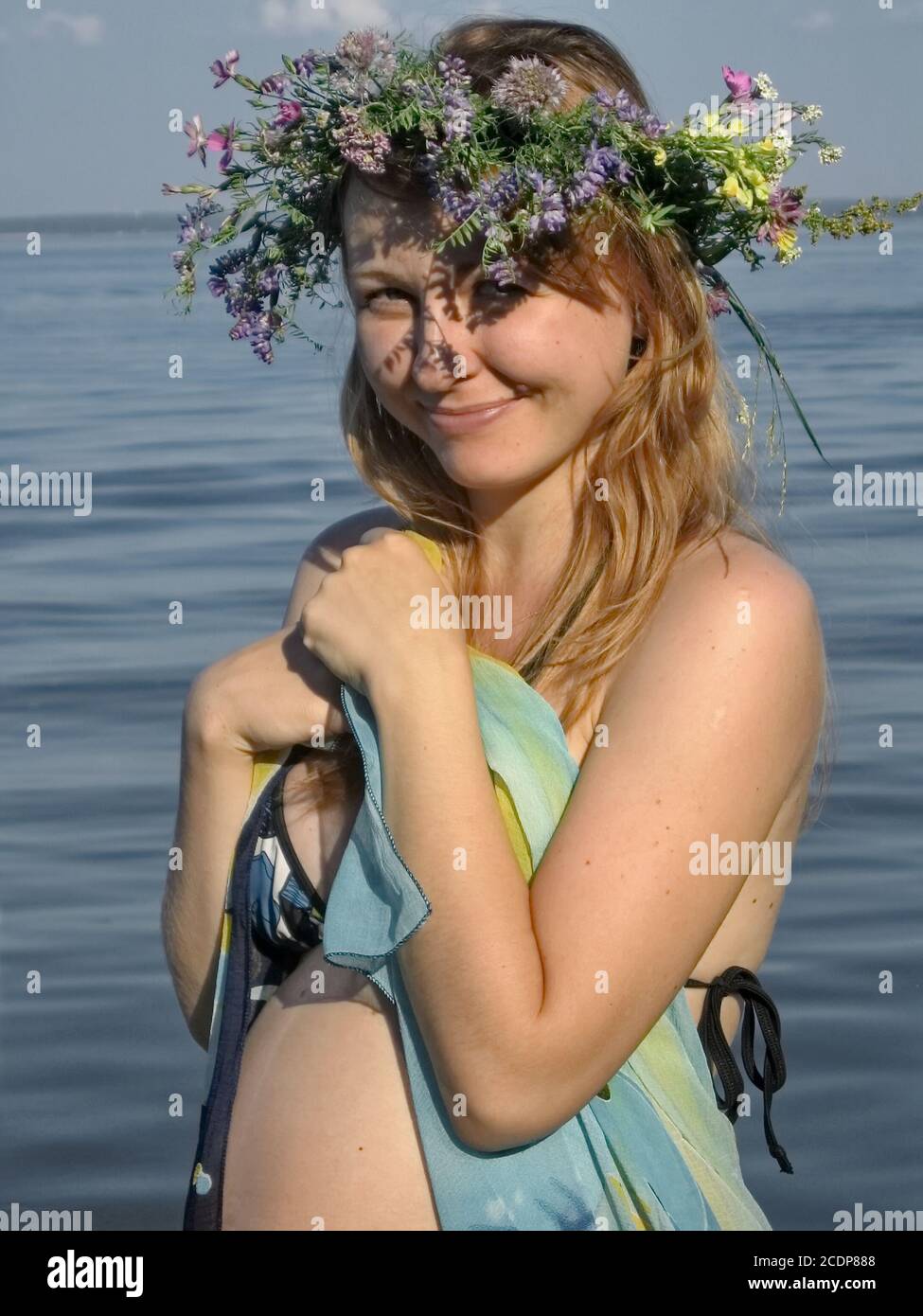 Schwangere Mädchen im Sommer in der Nähe des Meeres mit Kranz an Kopf Stockfoto