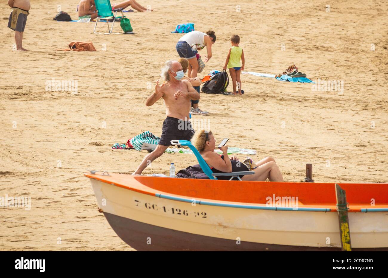 Las Palmas, Gran Canaria, Kanarische Inseln, Spanien. August 2020. Ein Mann mit Gesichtsmaske führt Yoga am Stadtstrand in Las Palmas auf Gran Canaria durch. Die Kanarischen Inseln haben im August einen großen Anstieg der Coronavirus-Infektionen erlebt, wobei Las Palmas die meisten Fälle registrierte. Kredit: Alan Dawson/Alamy Live Nachrichten Stockfoto