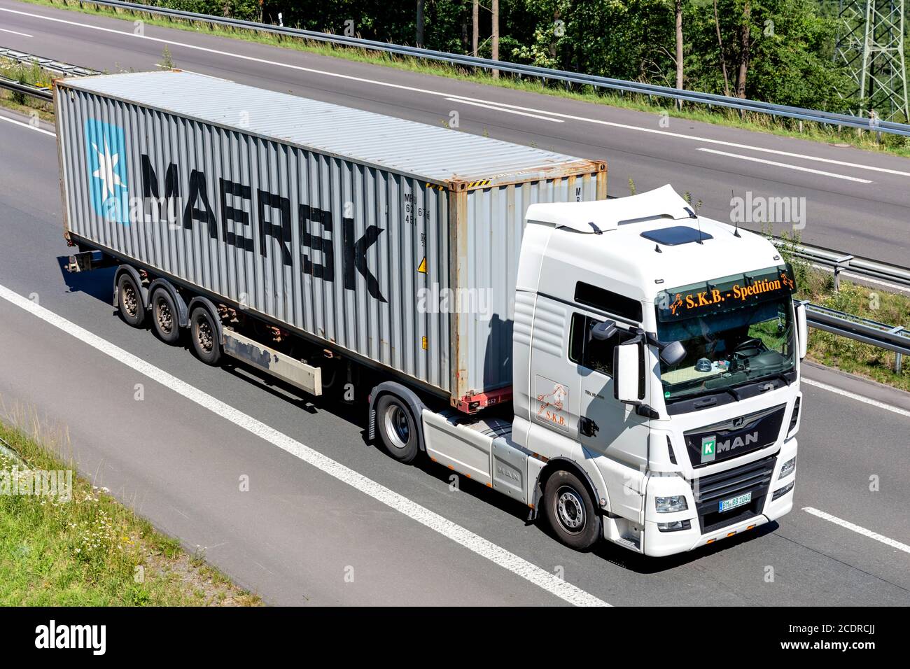 S.K.B Spedition MAN TGX LKW mit Maersk Container auf Autobahn. Stockfoto